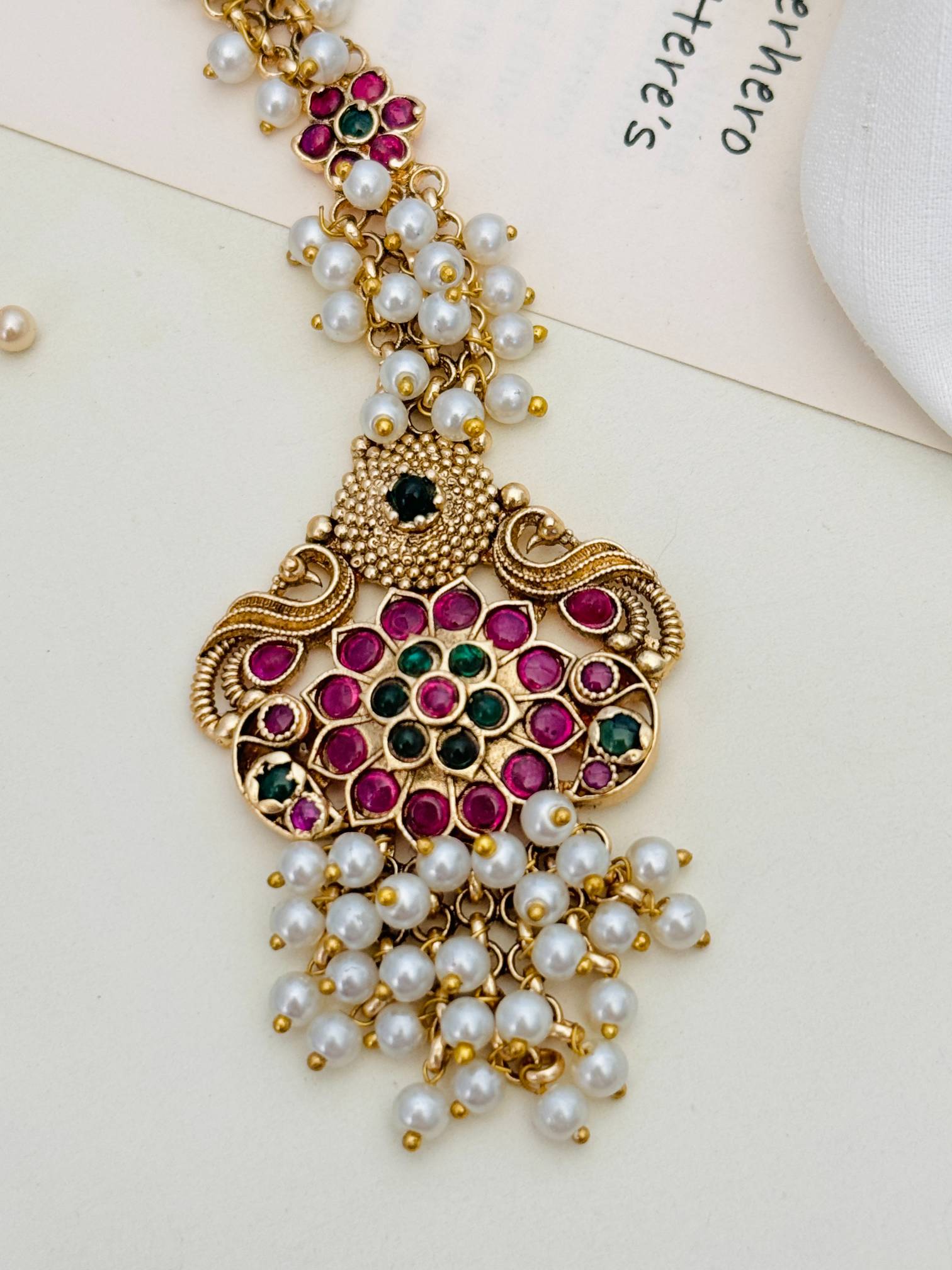 Traditional Matt Gold Plated SouthIndian Maangtikka with pink and green stones and pearl detailing