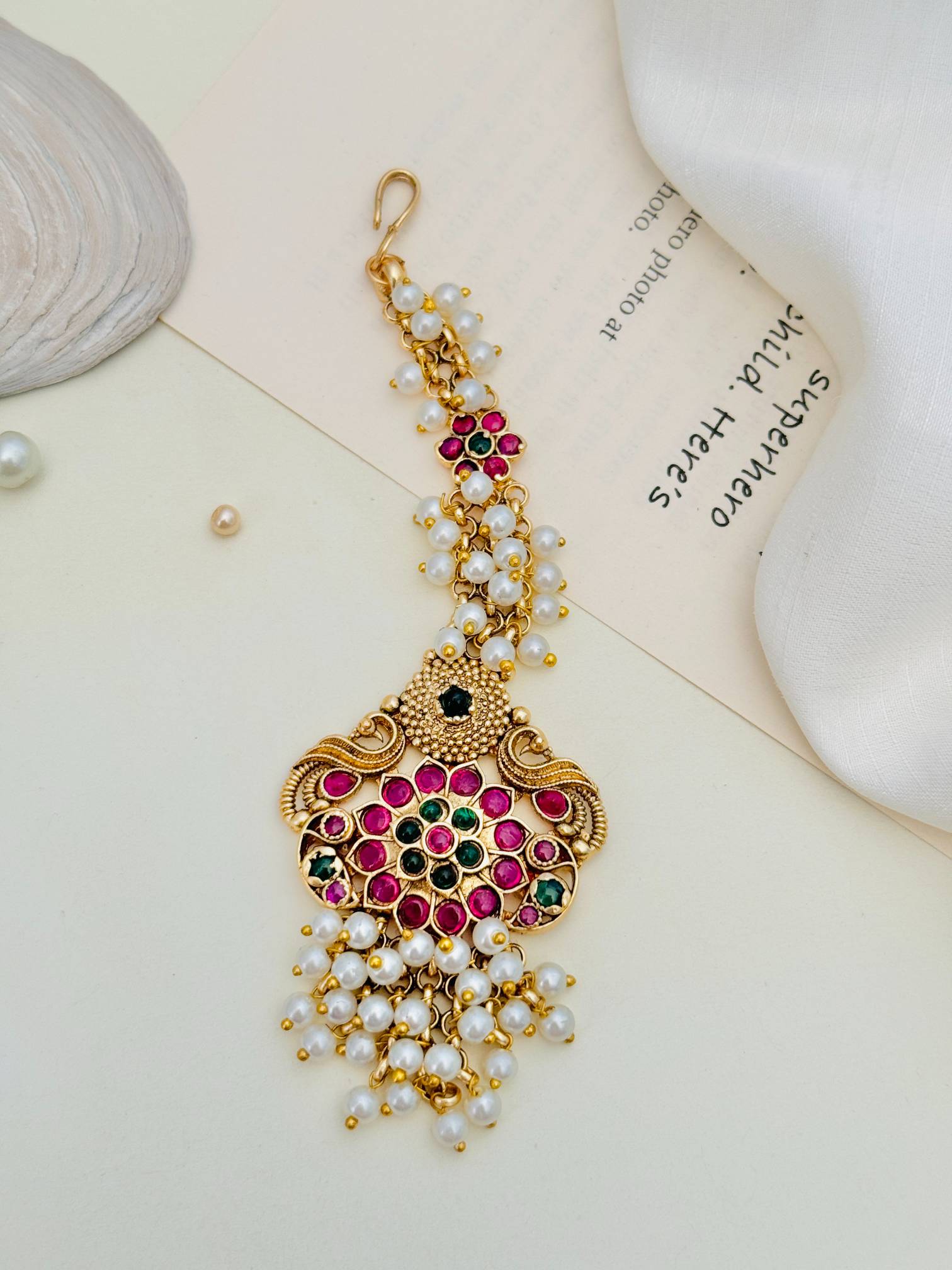 Traditional Matt Gold Plated SouthIndian Maangtikka with pink and green stones and pearl accents by Abdesignsjewellery