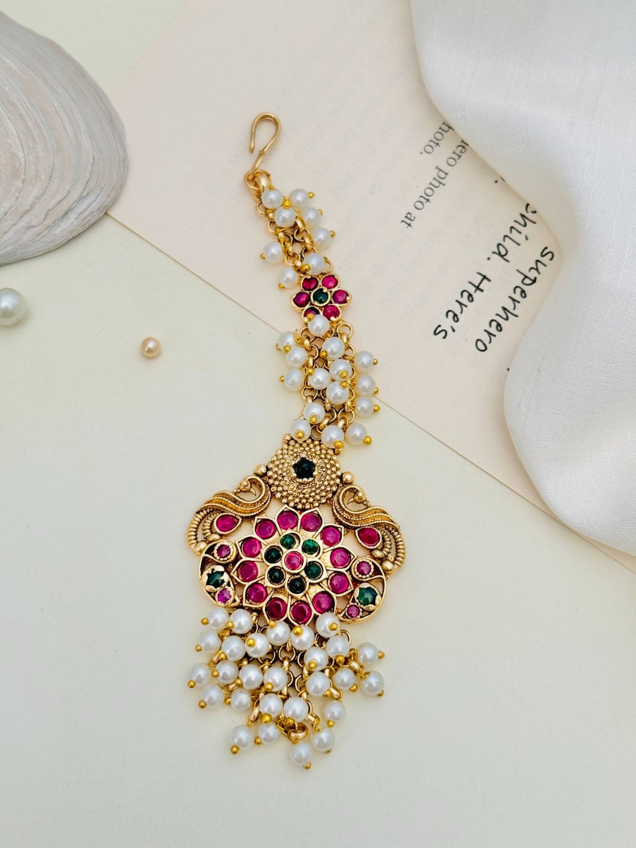 Traditional Matt Gold Plated SouthIndian Maangtikka with pink and green stones and pearl accents by Abdesignsjewellery