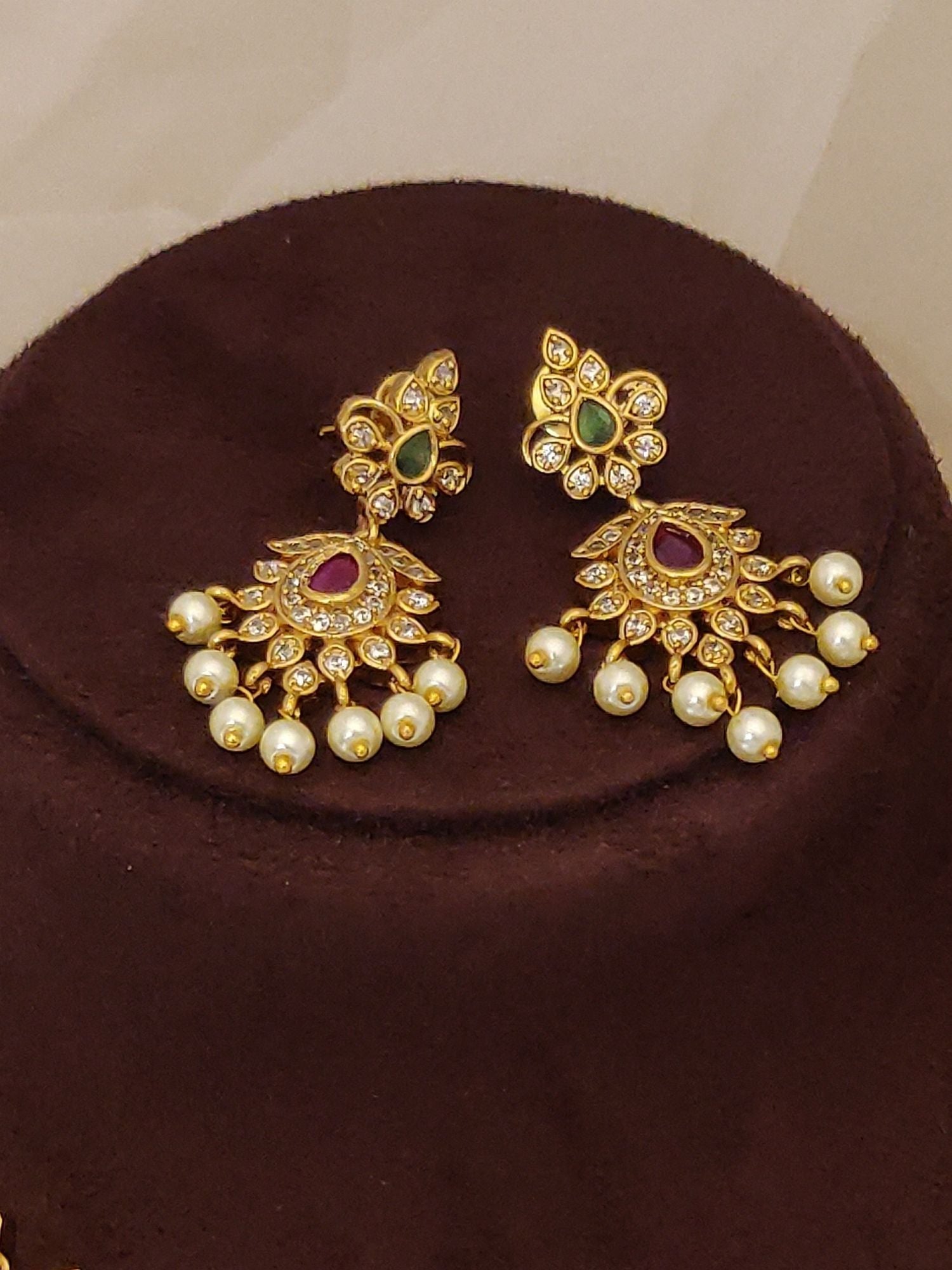 Gold plated jhumka earrings with pearls and kundan stones matching Traditional South Indian gold plated necklace set