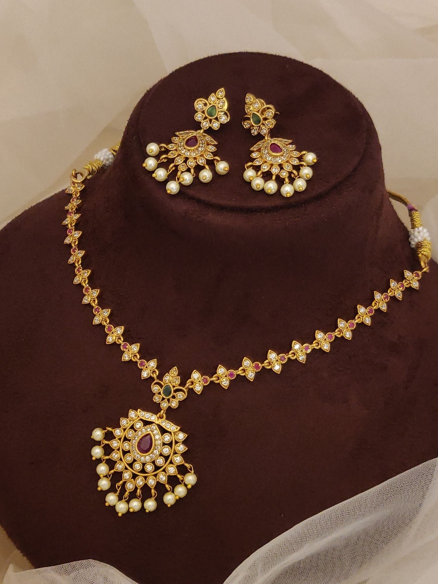 Traditional South Indian gold plated necklace set. pendant with pearl drops and matching red green stone earrings