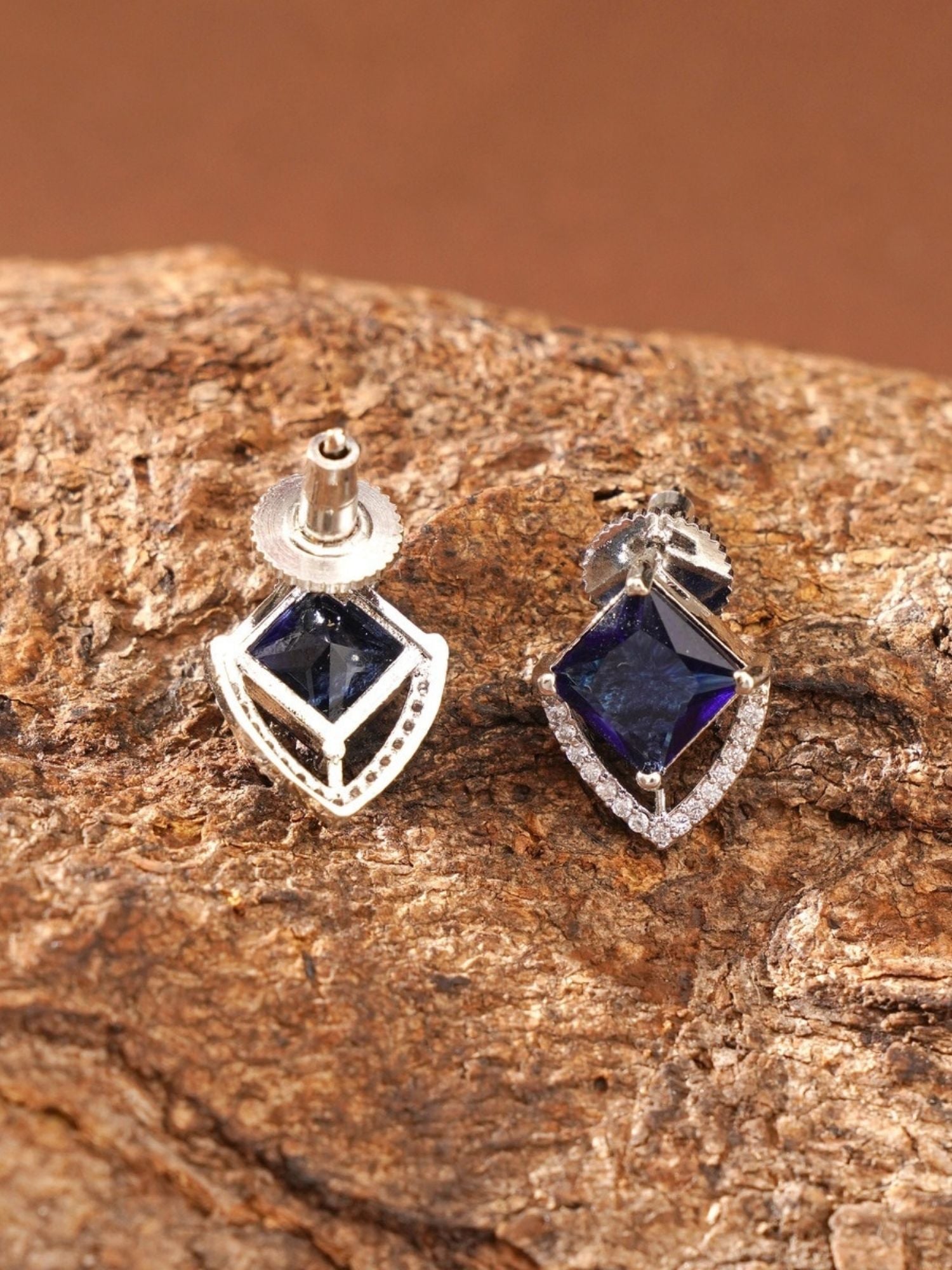 Unique Silver Plated American Diamond Stud Earring with blue square gemstone on textured surface