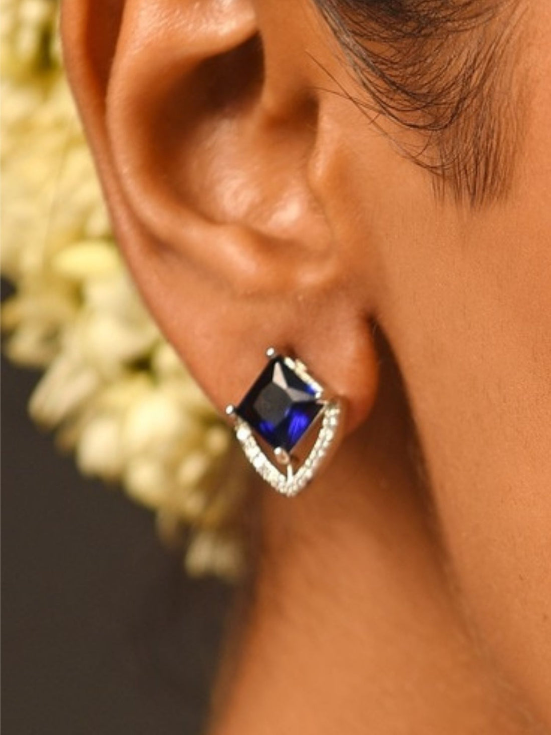 Unique Silver Plated American Diamond Stud Earring with blue center stone worn by model from Abdesignsjewellery