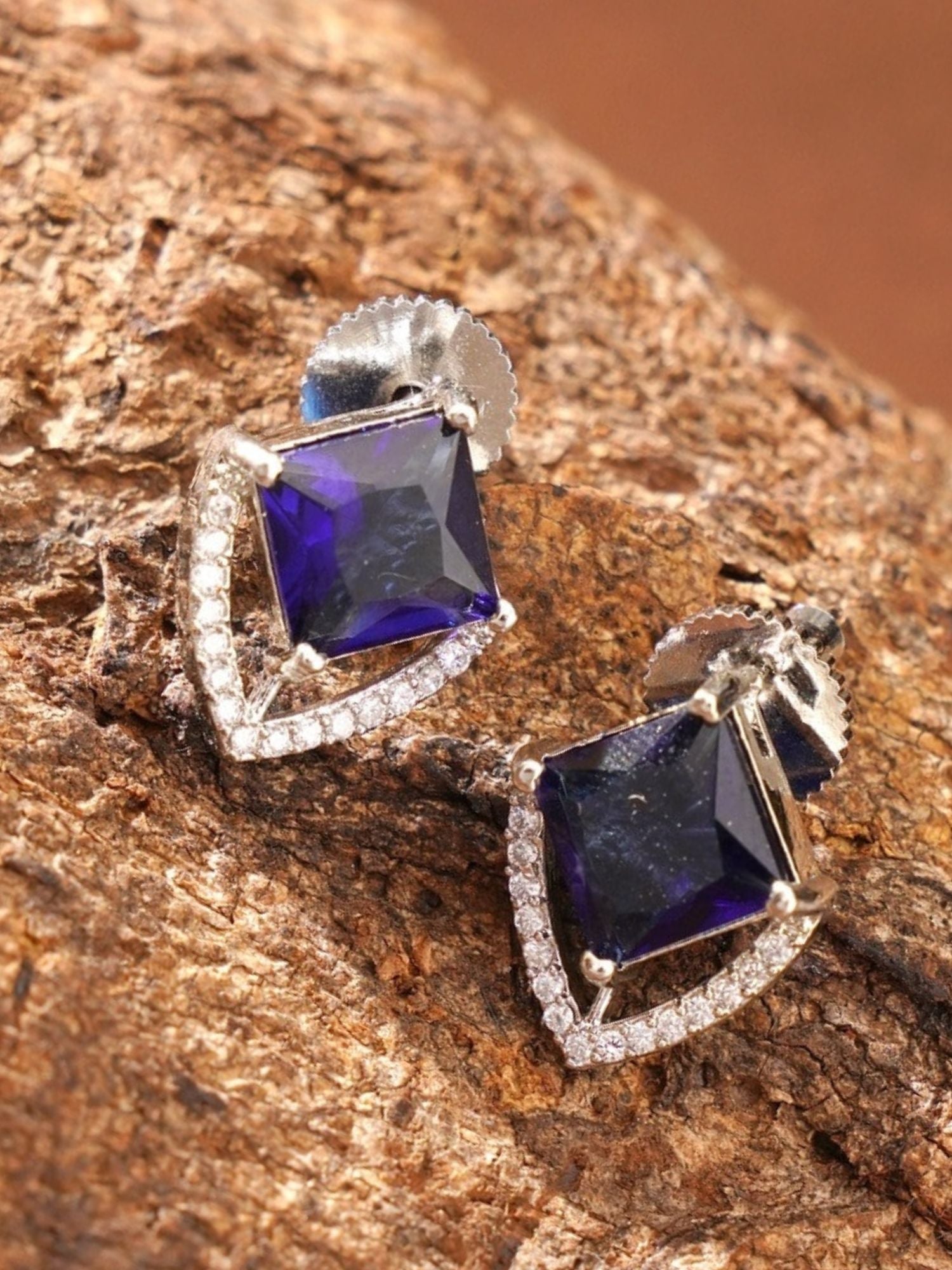 Unique Silver Plated American Diamond Stud Earring with square purple gemstone on textured background