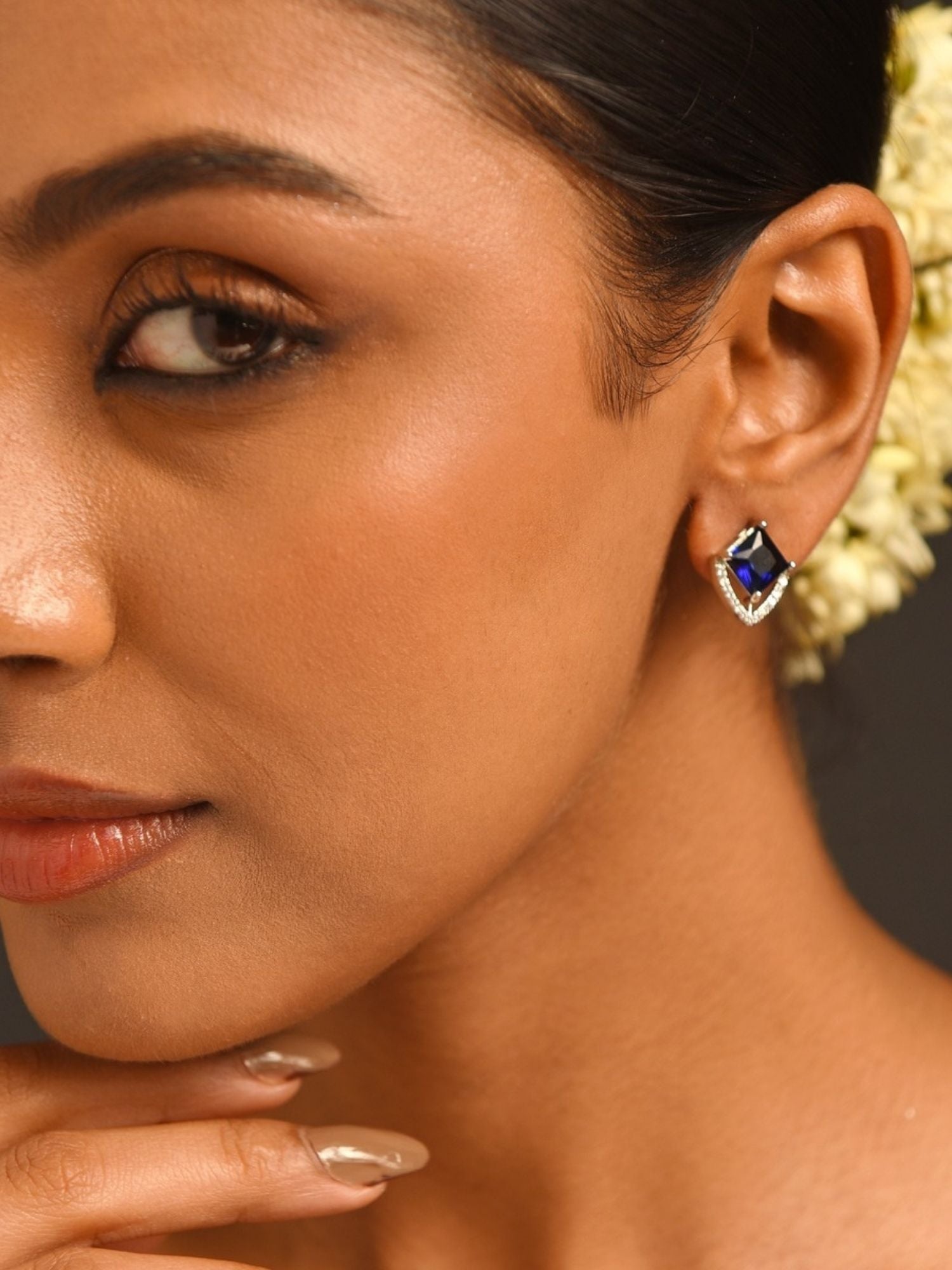 Unique Silver Plated American Diamond Stud Earring with blue center stone worn by model from Abdesignsjewellery