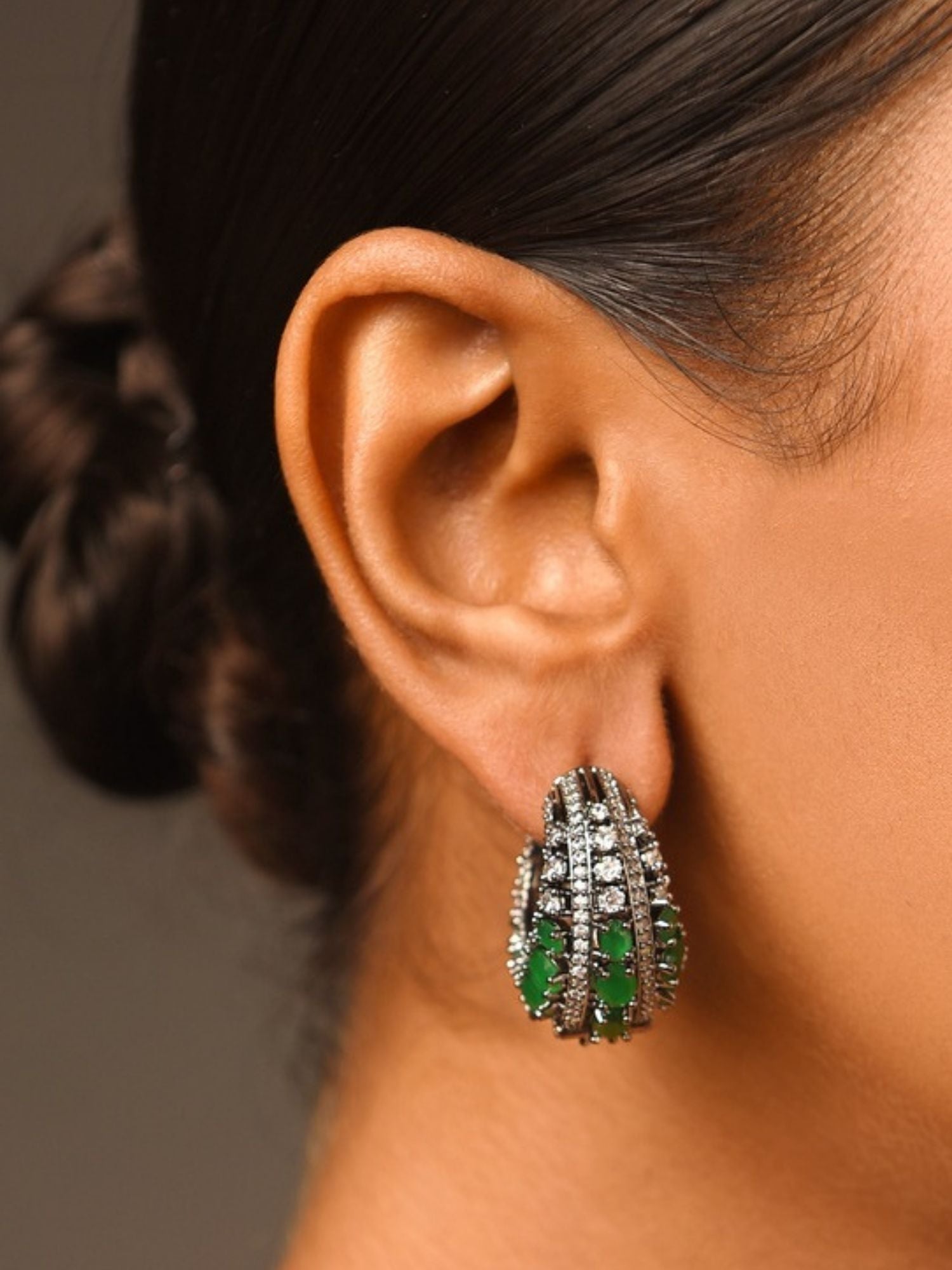Versatile Silver Plated American Diamond Hoops Earring on model ear with green gemstone accents Abdesignsjewellery