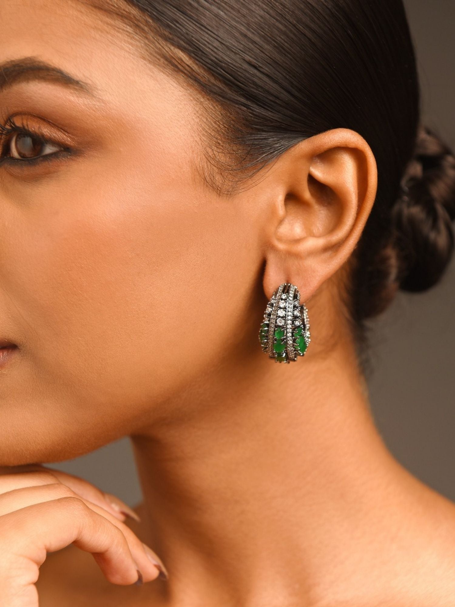 Versatile Silver Plated American Diamond Hoops Earring worn by model featuring green gemstone accents and clear stones