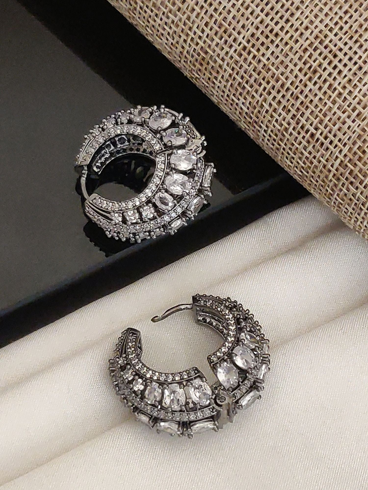 Versatile Silver Plated American Diamond Hoops Earring by Abdesignsjewellery ornate pave and pear stones on textured background