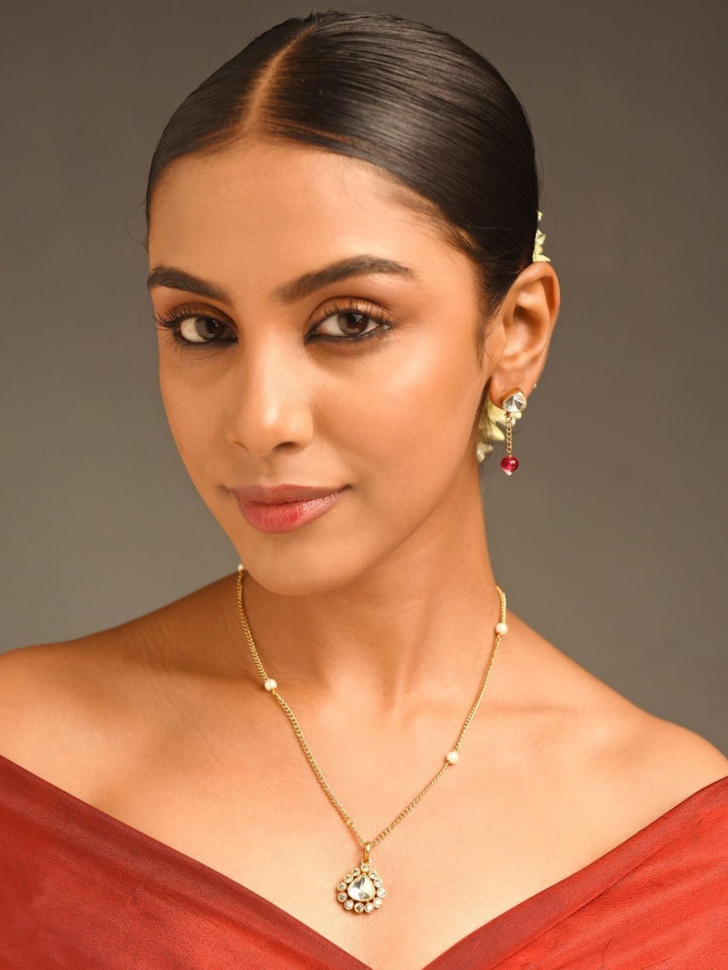 Vibrant Gold Plated Polki Pendant Chain With Earrings on model showcasing delicate gold polki pendant and matching earrings