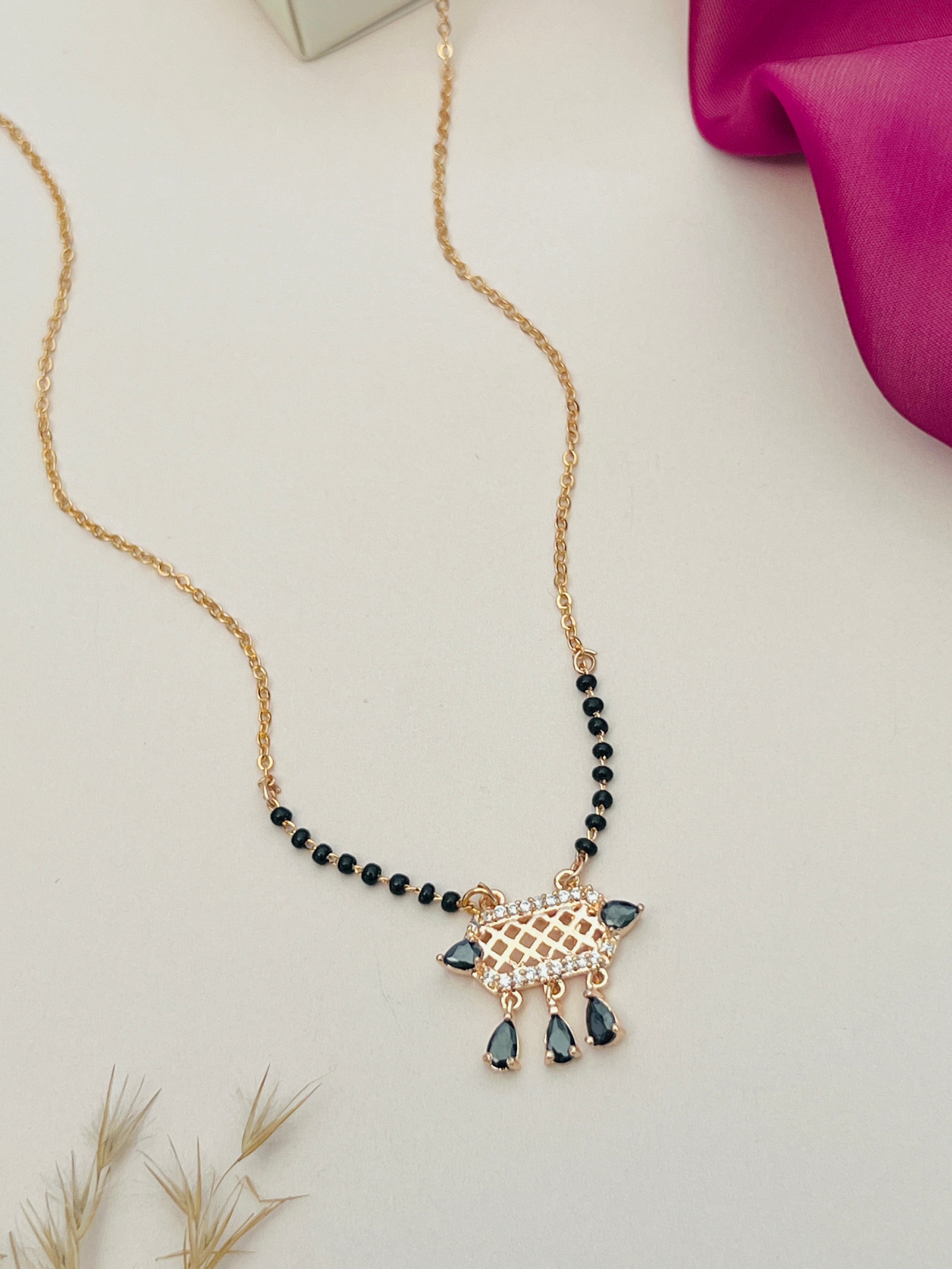 American Diamond Mangalsutra by Abdesignsjewellery with black beads and gold chain featuring drop-shaped diamond pendant