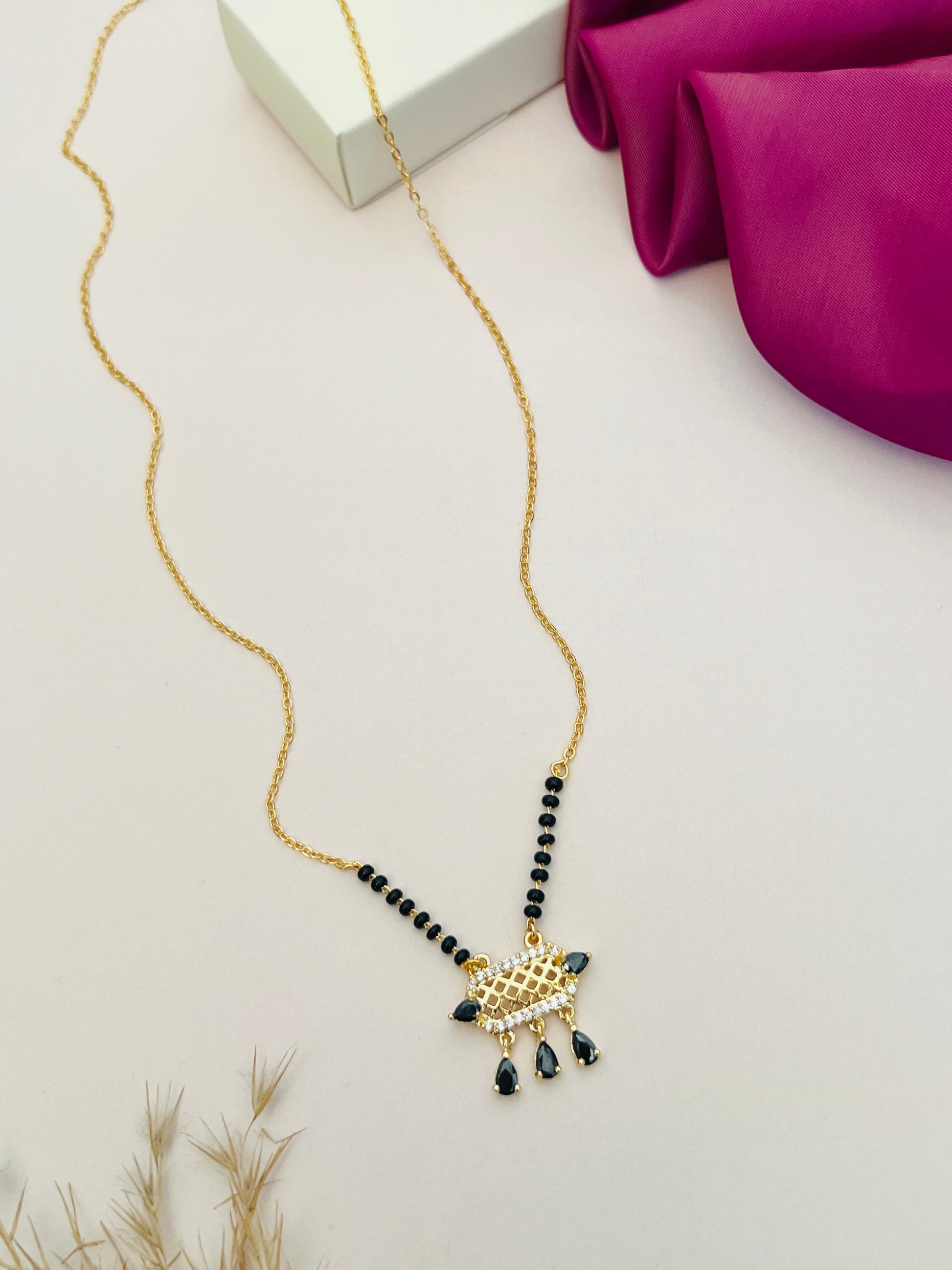 Abdesignsjewellery American Diamond Mangalsutra with black beads and gold pendant on white background
