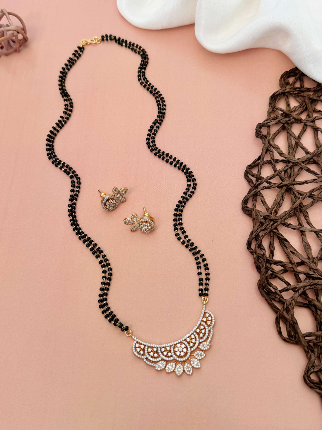Elegant American Diamond Mangalsutra Set with intricate pendant worn by woman in black dress