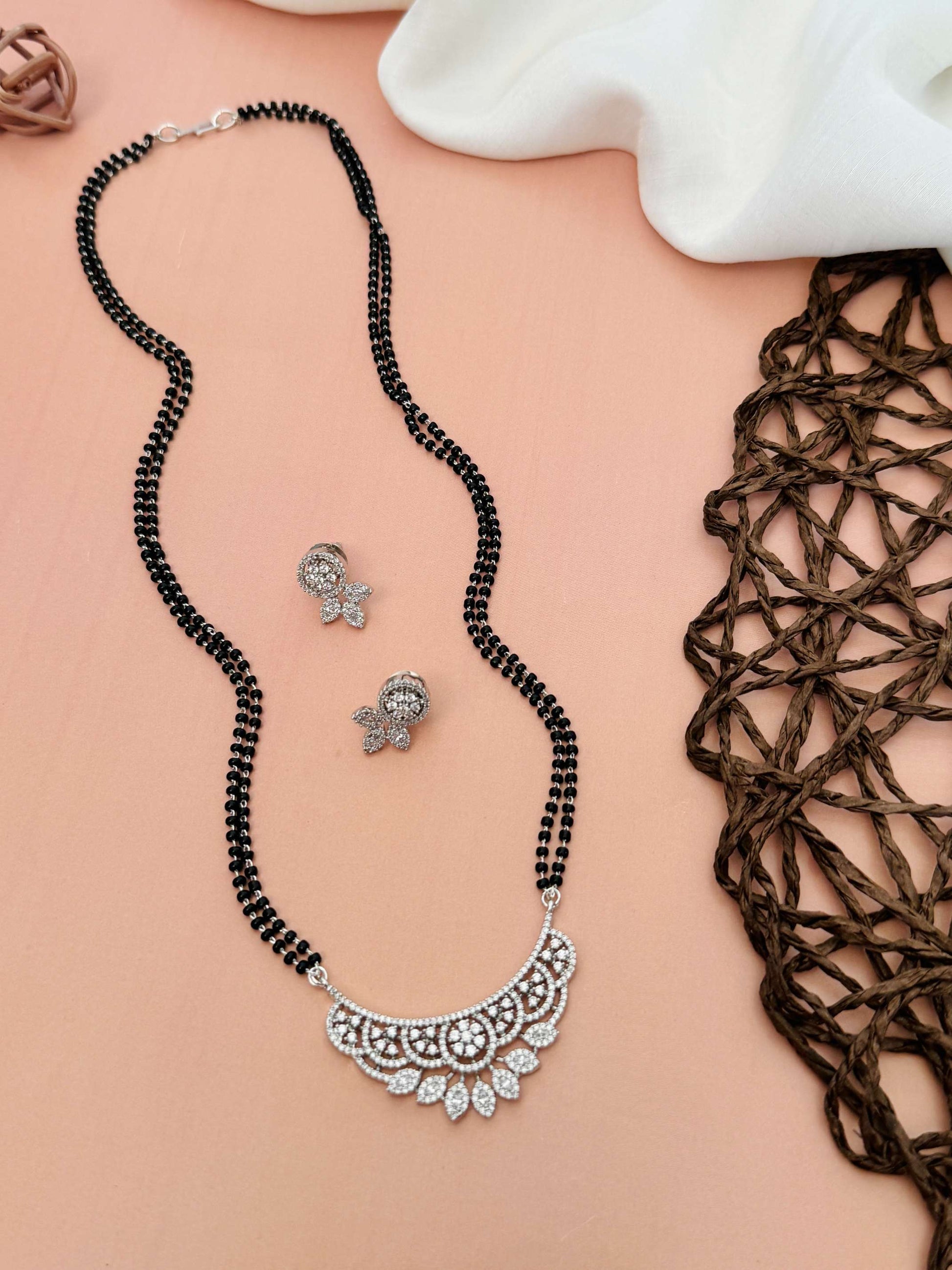 Abdesignsjewellery American Diamond Mangalsutra Set with black beads and intricate silver pendant with matching earrings