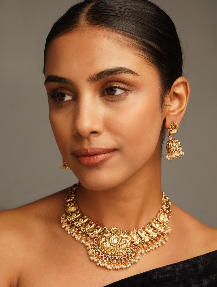 Antique Golden Plated Matt Finish Necklace Set worn by woman featuring intricate traditional design and matching earrings