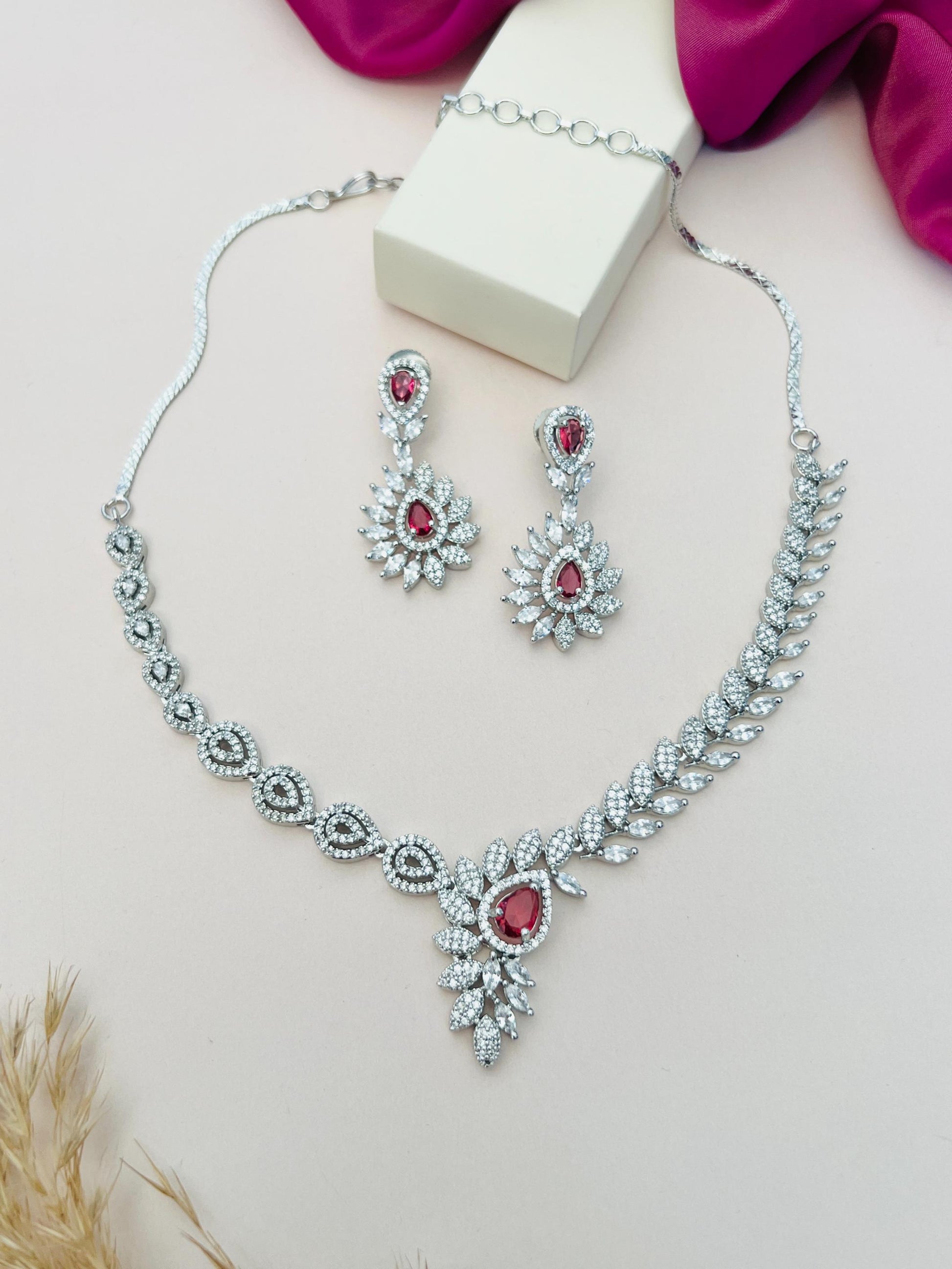 Artistic Silver Plated American Diamond Necklace with matching earrings featuring red and clear stones