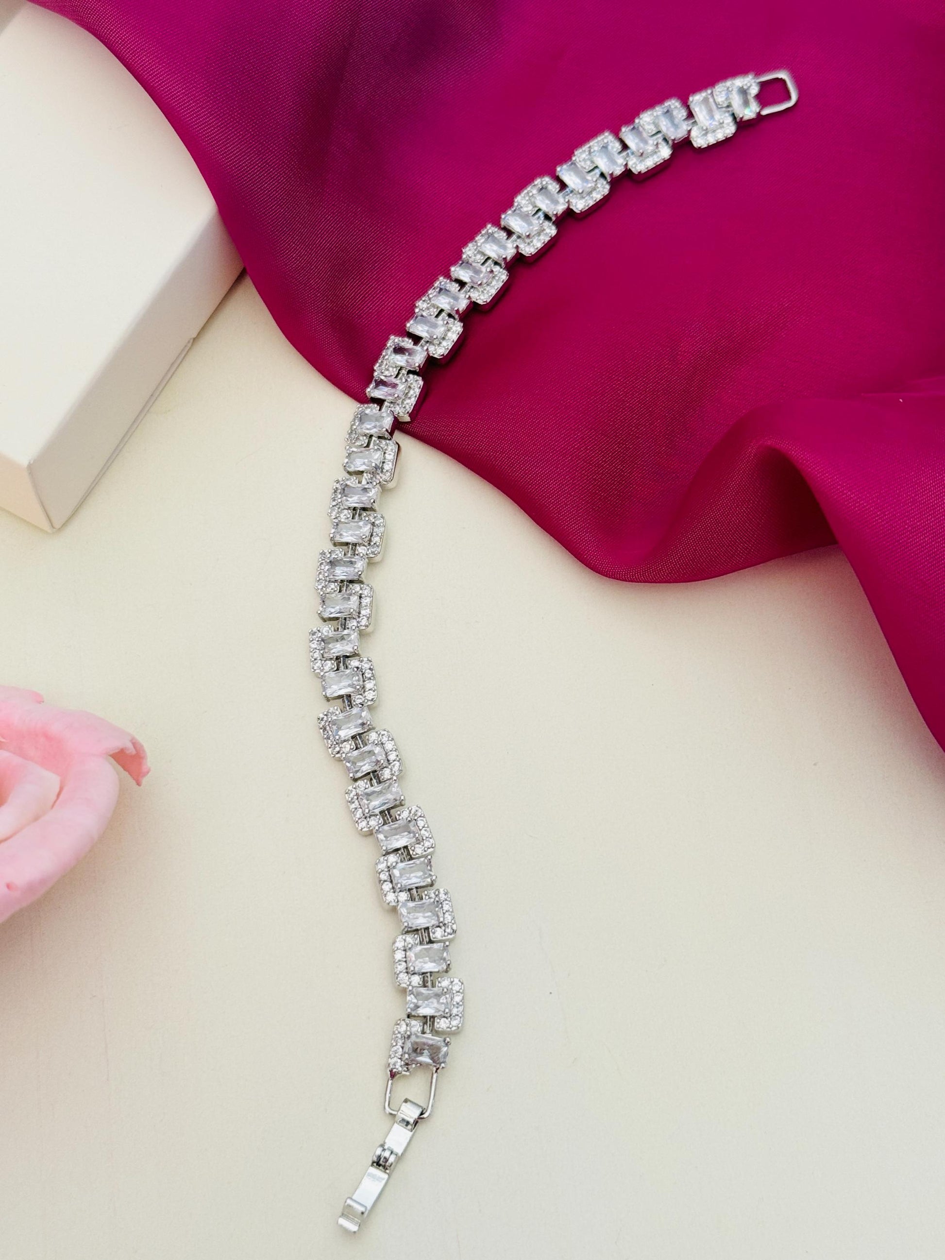 Beautiful High Quality Silver Bracelet by Abdesignsjewellery with intricate linked design on pink fabric