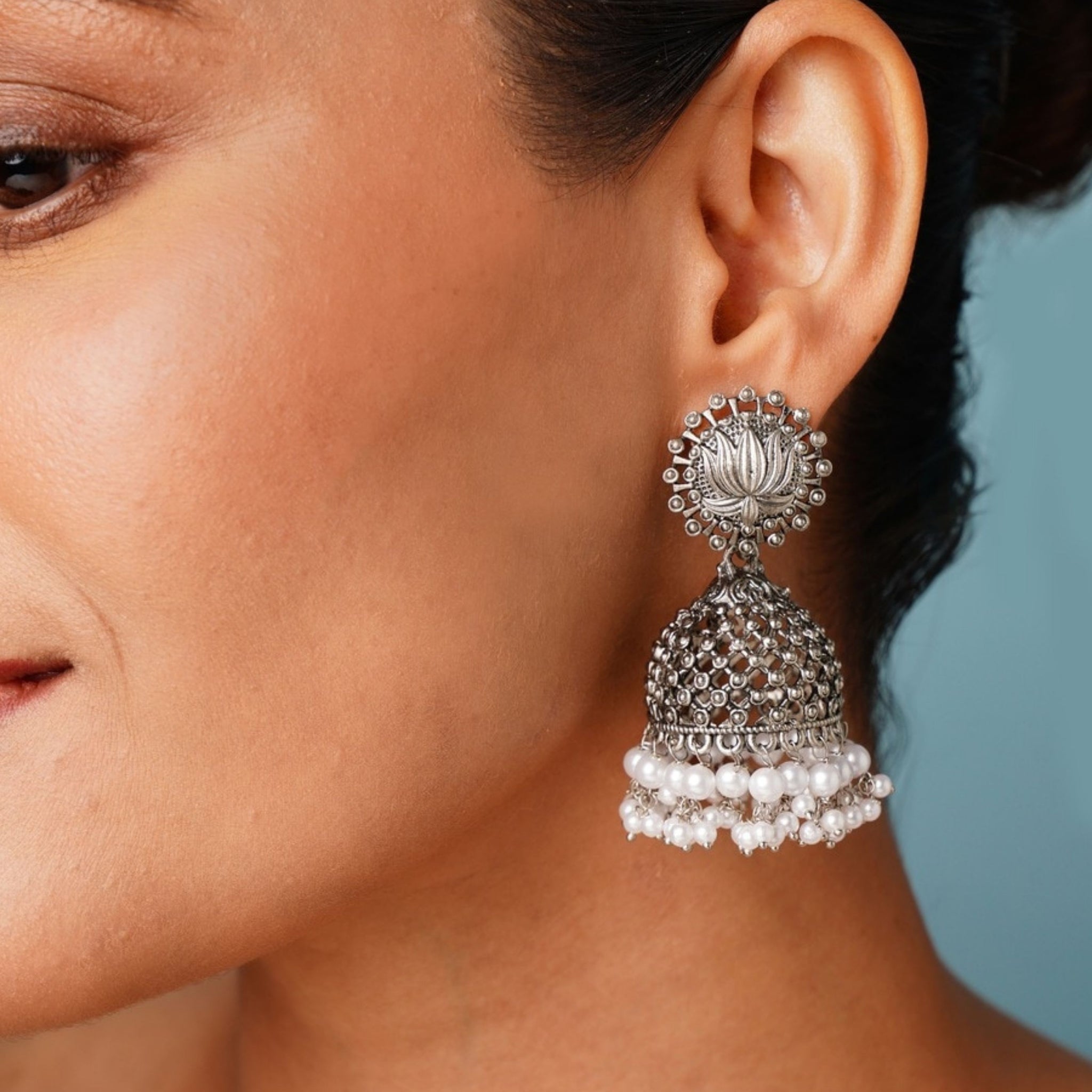 Classic German Silver Pearls Jhumka Earring by Abdesignsjewellery worn on woman's ear with intricate detailing and pearl accents