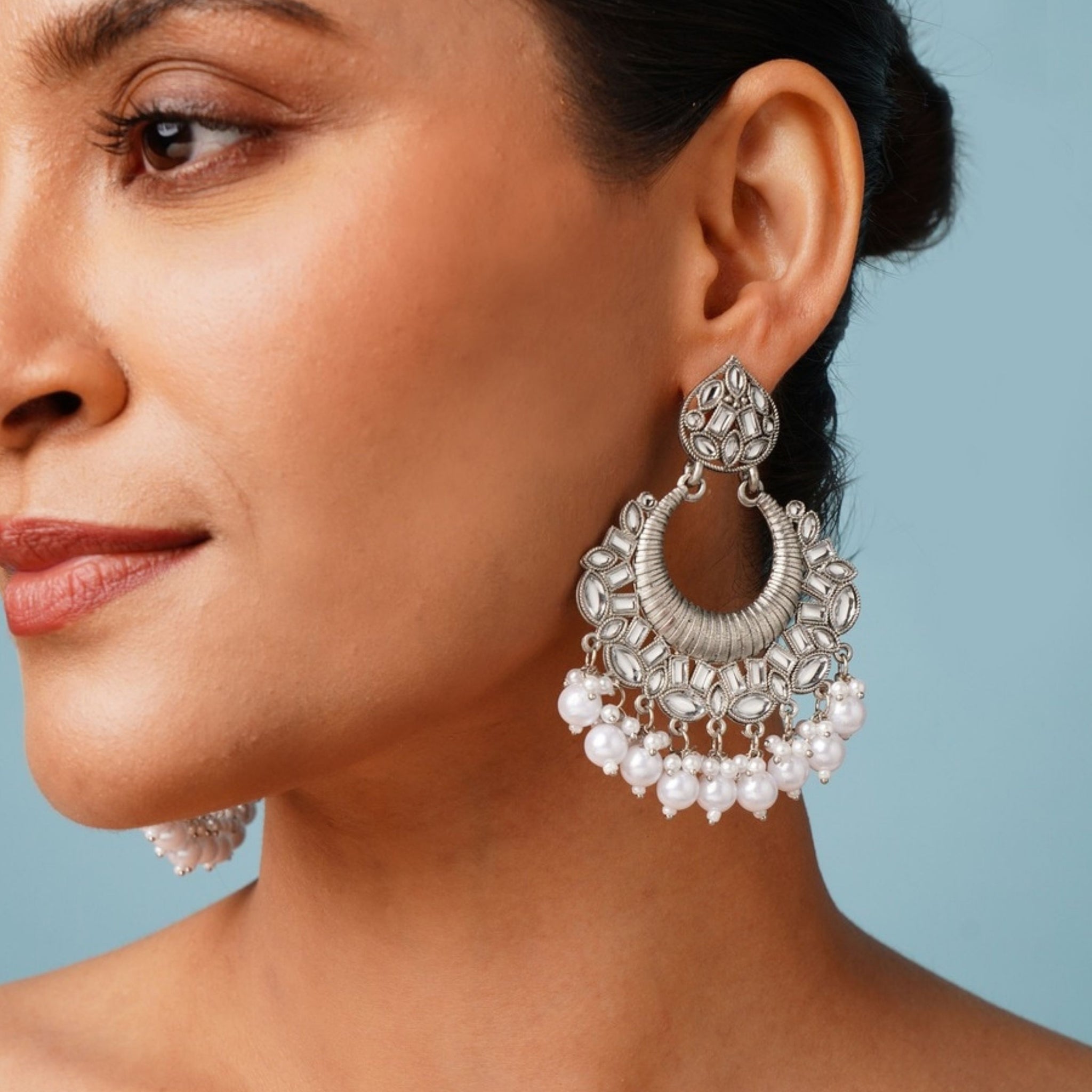 Classic German Silver Plated Chandbali Earring worn by woman showcasing detailed design and pearl accents