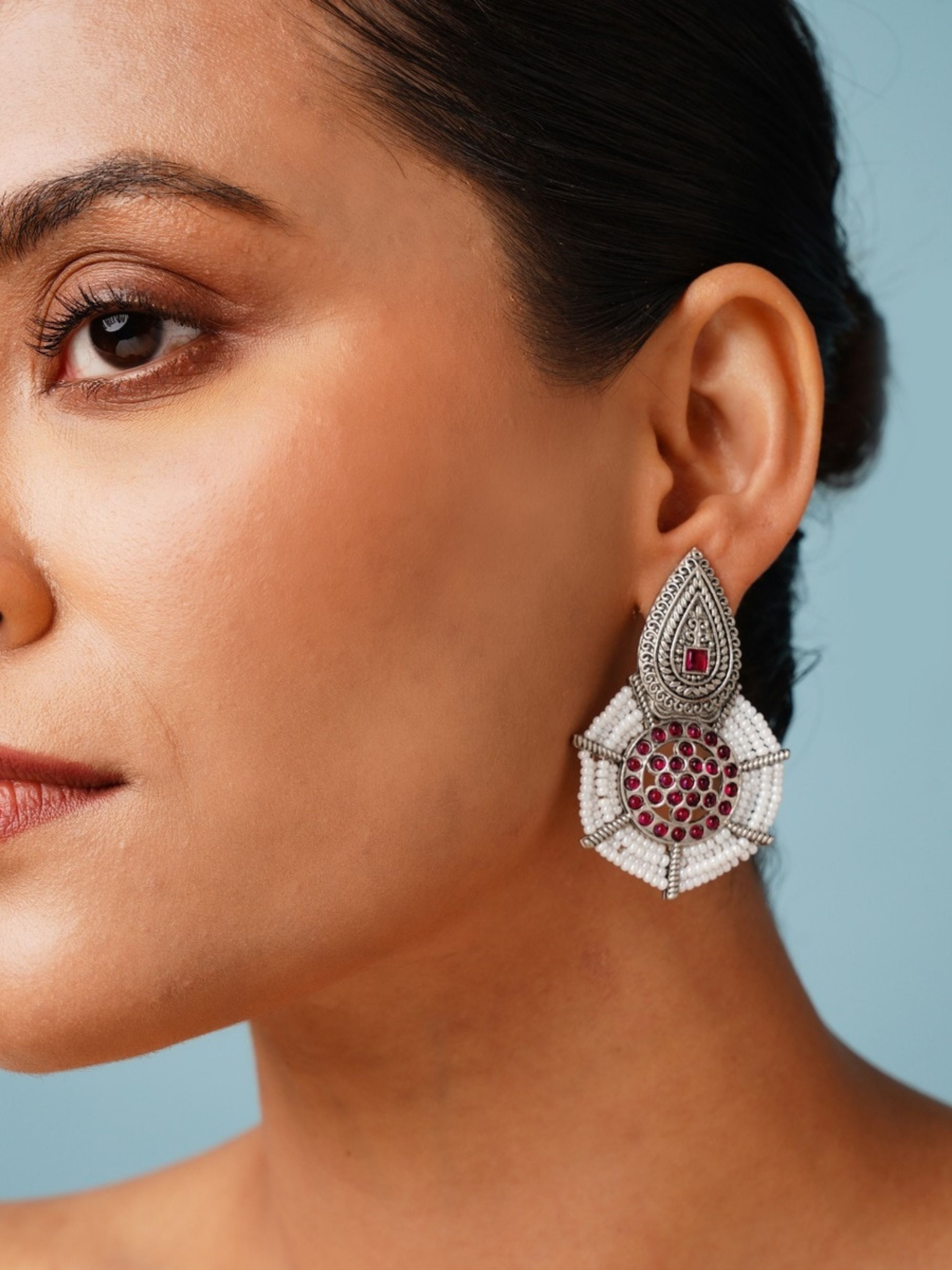 Abdesignsjewellery German Silver Pearl Earring with intricate design and red gemstone accents worn by a woman