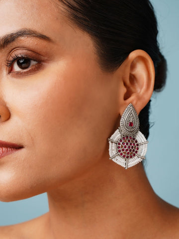Abdesignsjewellery German Silver Pearl Earring with intricate design and red gemstone accents worn by a woman