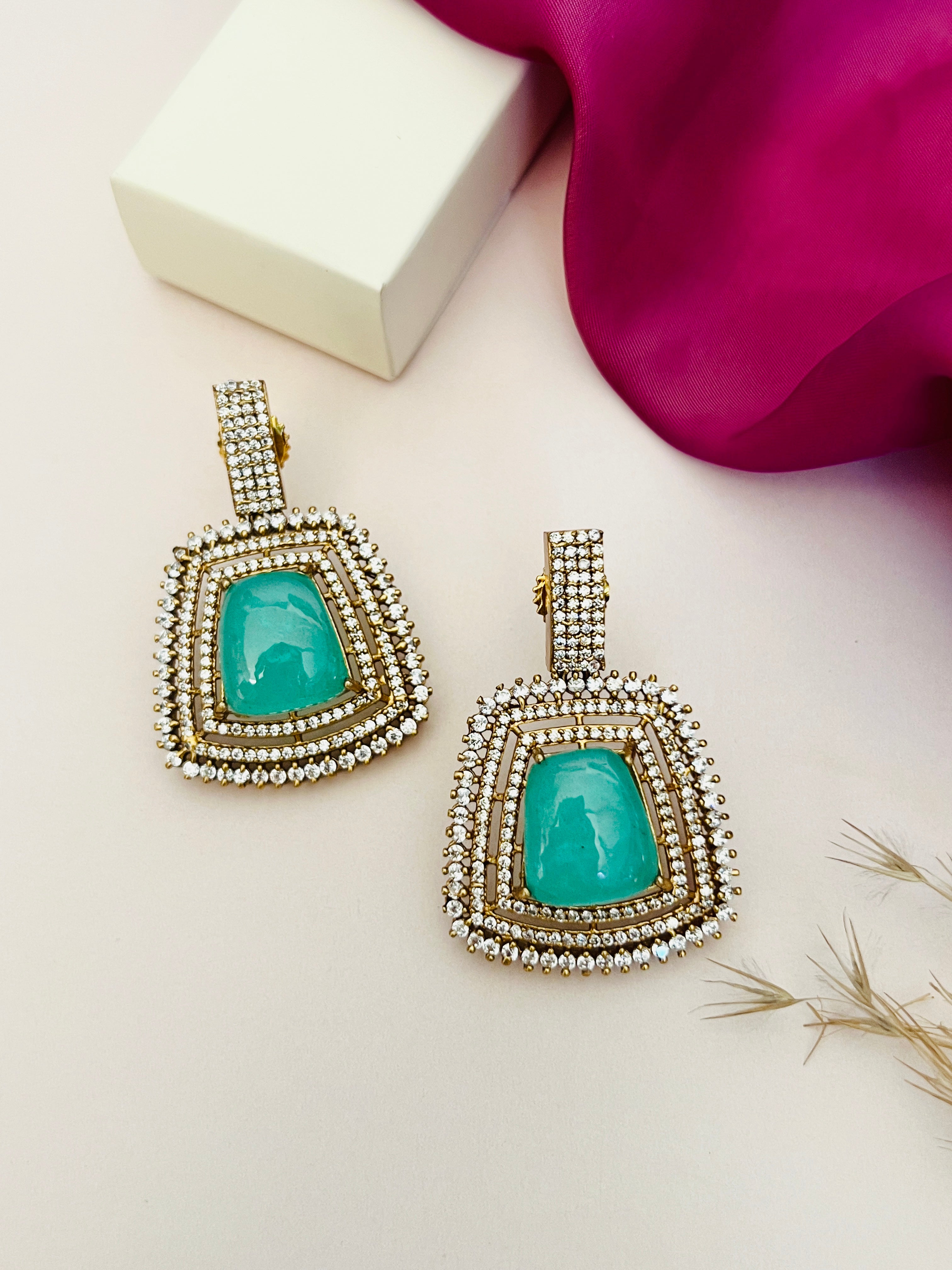 Emerald Stone Sabyasachi Necklace Set earrings with green stones and intricate white stone detailing