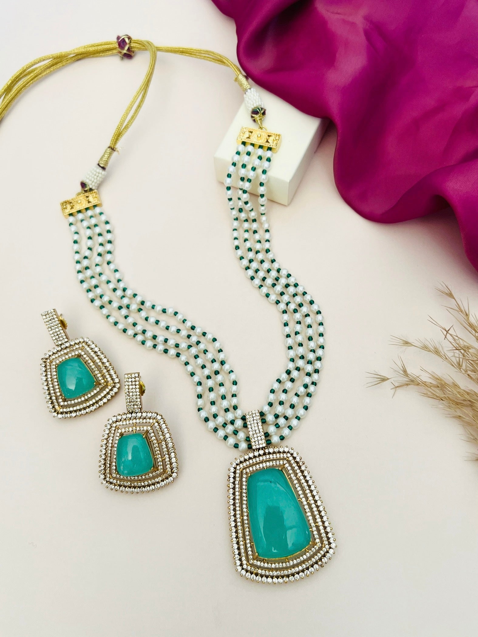 Emerald Stone Sabyasachi Necklace Set featuring a multi-strand beaded necklace and matching earrings by Abdesignsjewellery