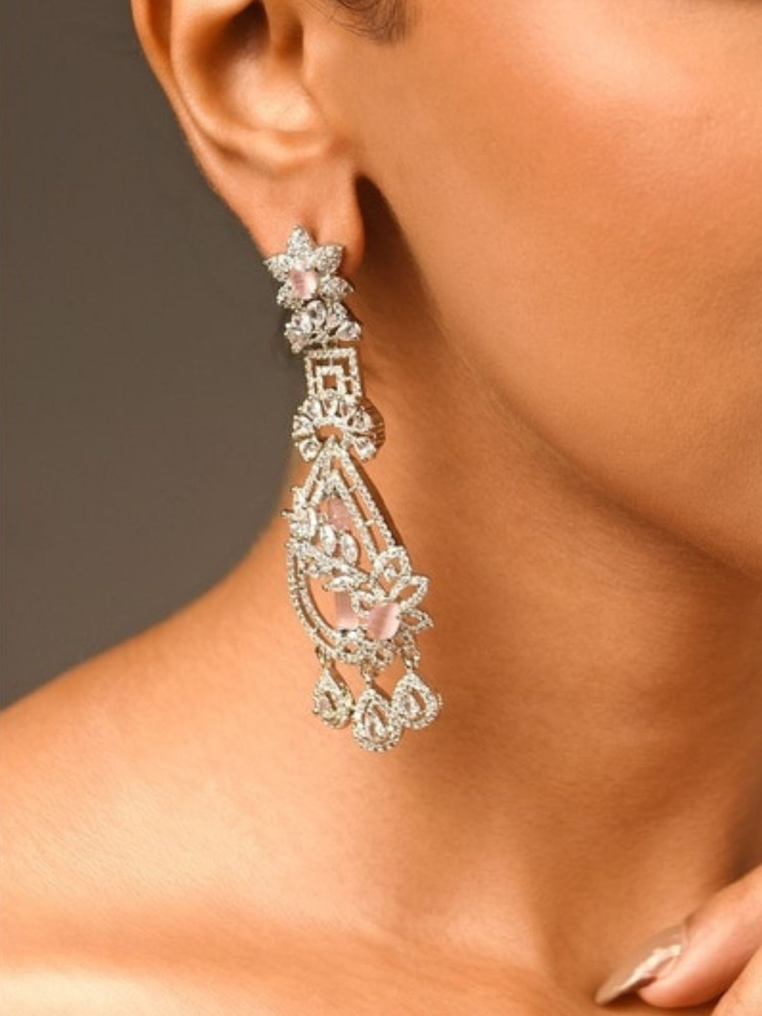 Fascinating Silver Plated Pink American Diamond Earring worn by model showcasing intricate design