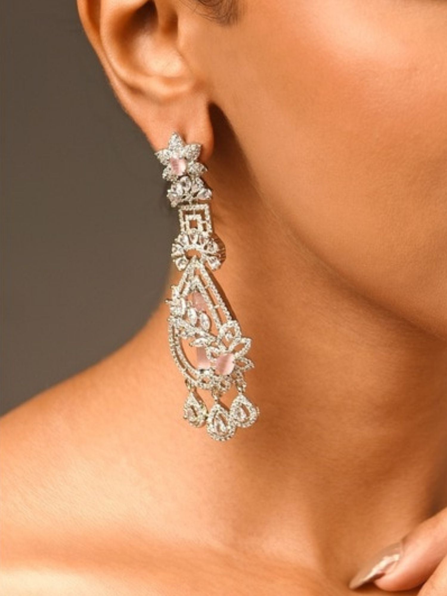 Fascinating Silver Plated Pink American Diamond Earring worn on ear with intricate floral design