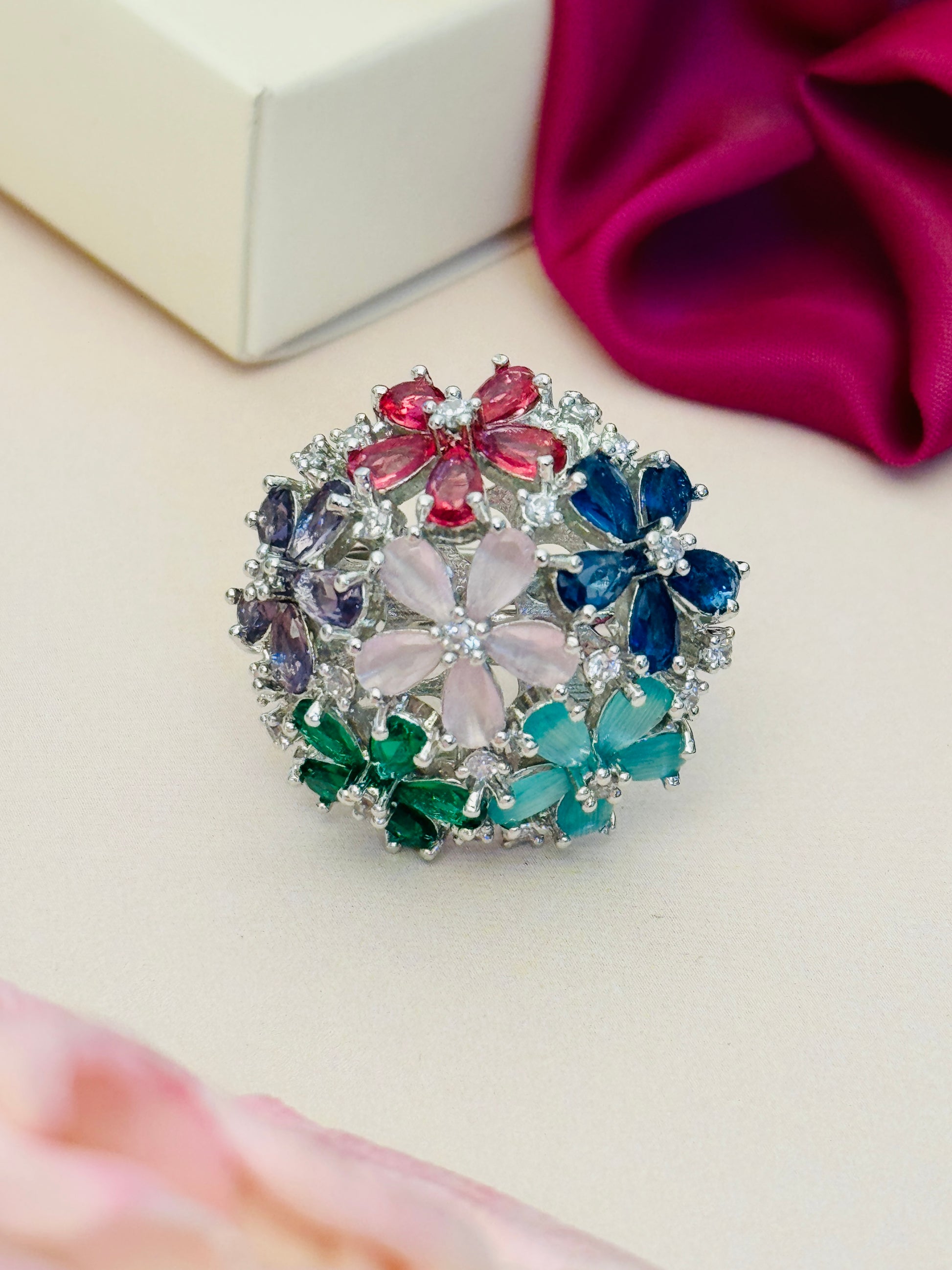 Floral Silver Plated Zircon Cocktail Party Ring with multicolored flower-shaped stones on a white surface