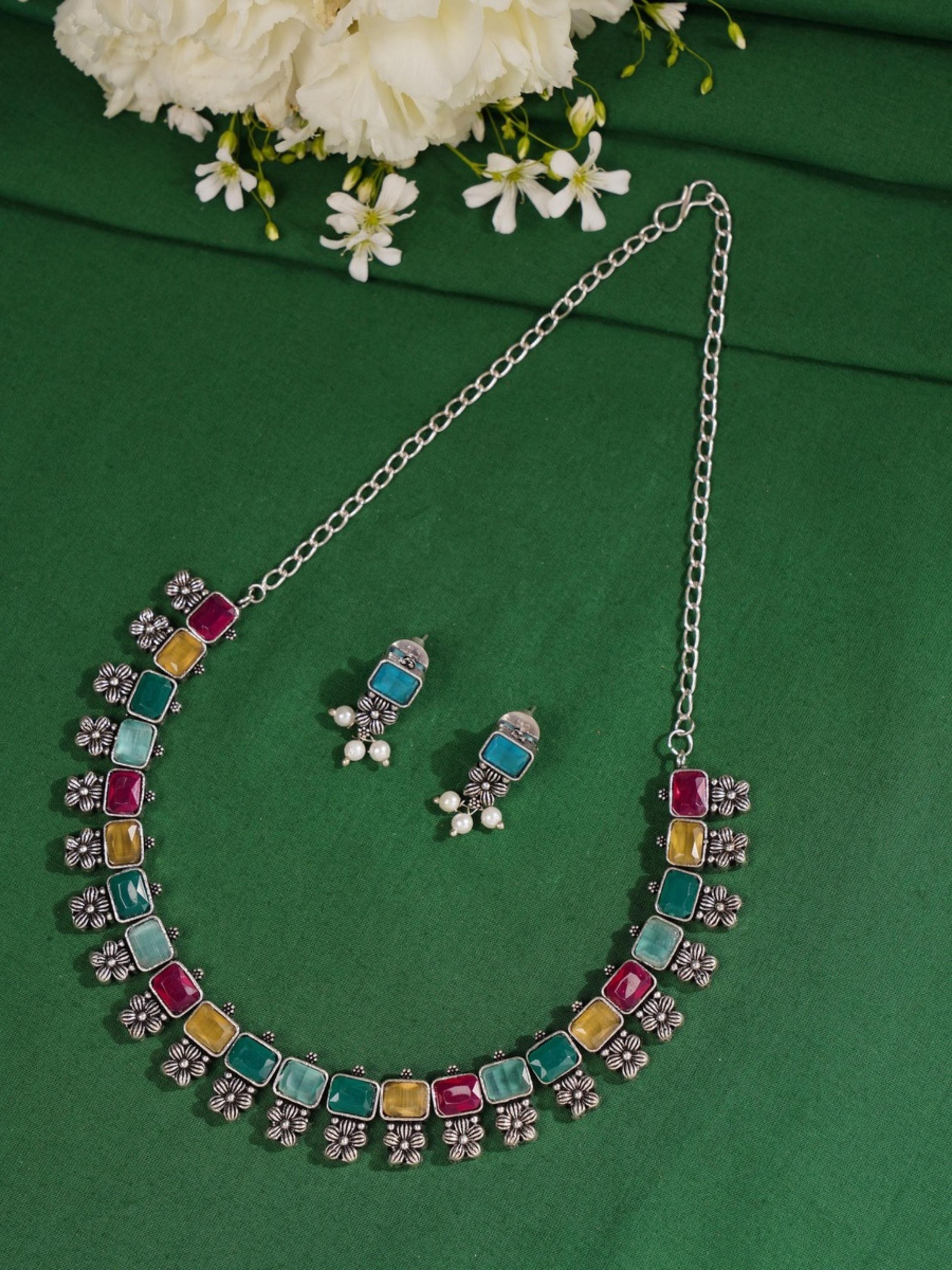 Abdesignsjewellery German Silver Multicolour Floral Necklace Set with matching earrings on green fabric background