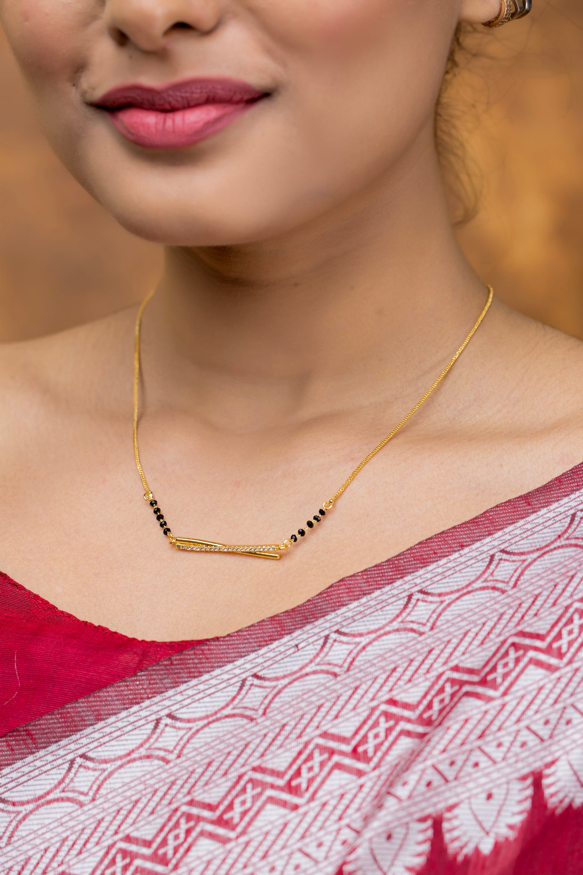 Elegant Gold Plated American Diamond Mangalsutra worn by a woman in a traditional red and silver sari