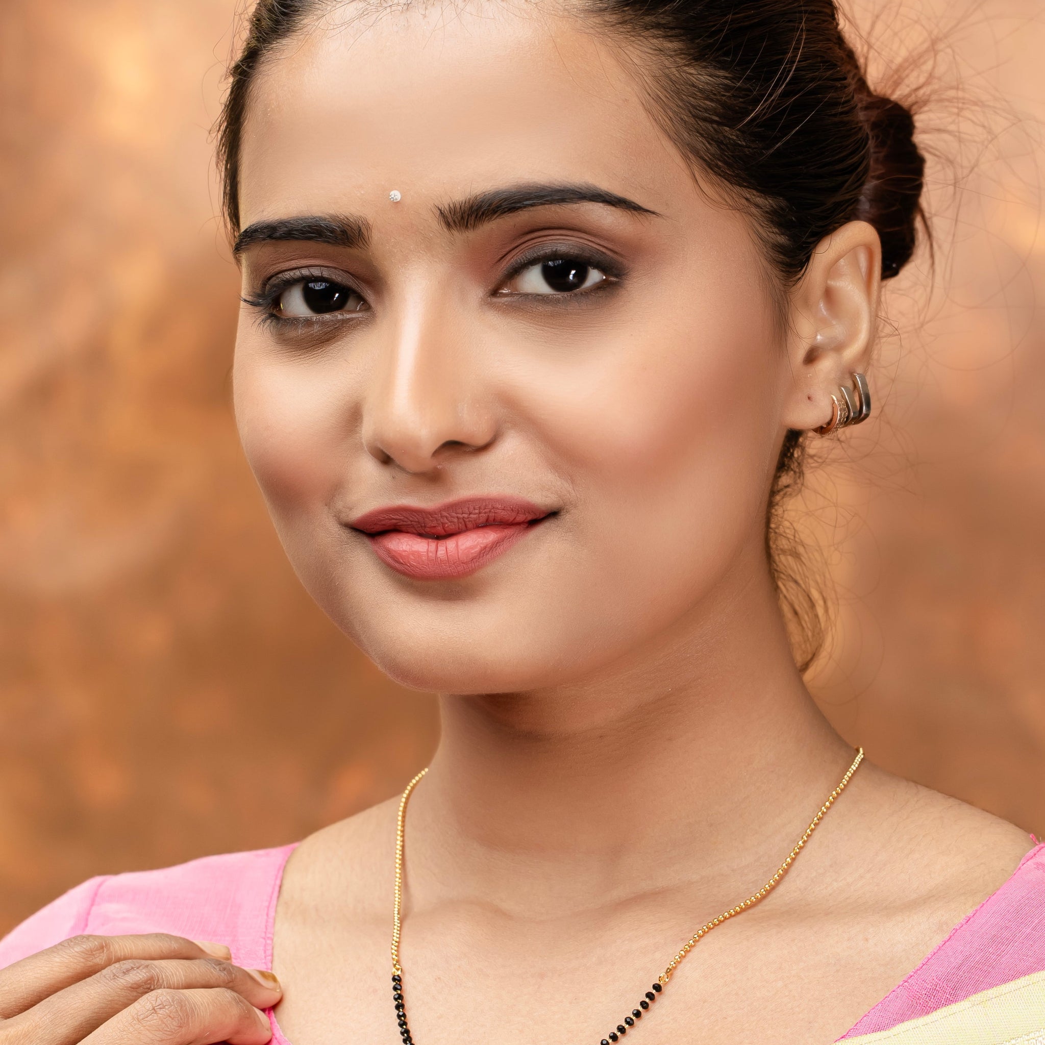 Elegant Gold Plated American Diamond Mangalsutra worn by woman with a pink blouse and light saree