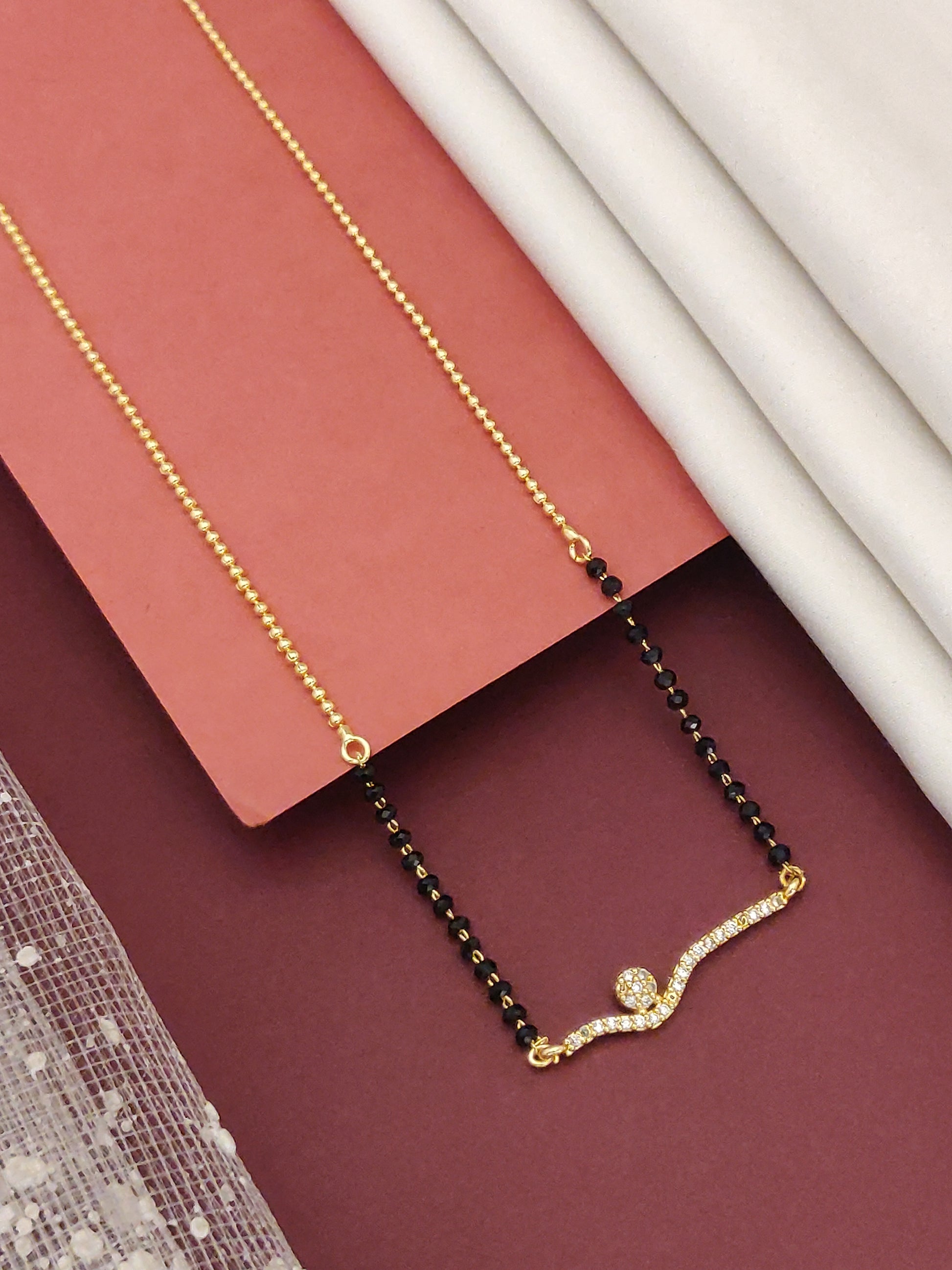 Gold Plated American Diamond Mangalsutra with a unique design and elegant black beads