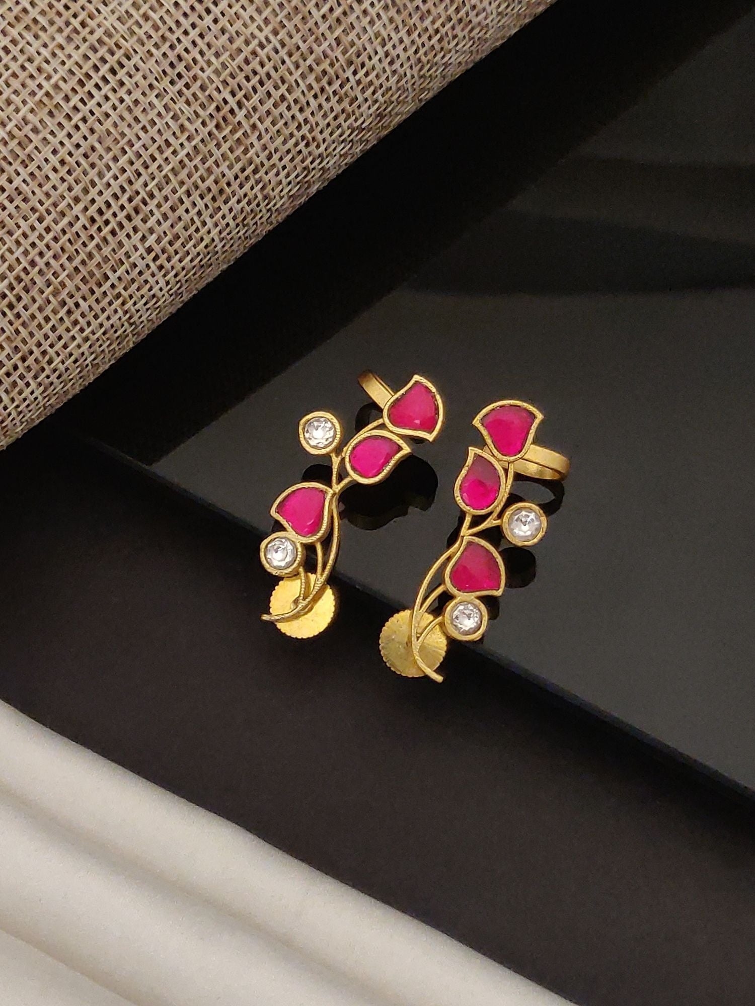 Gold Plated Artificial Stone Floral Earring with pink stones and clear crystals on black background