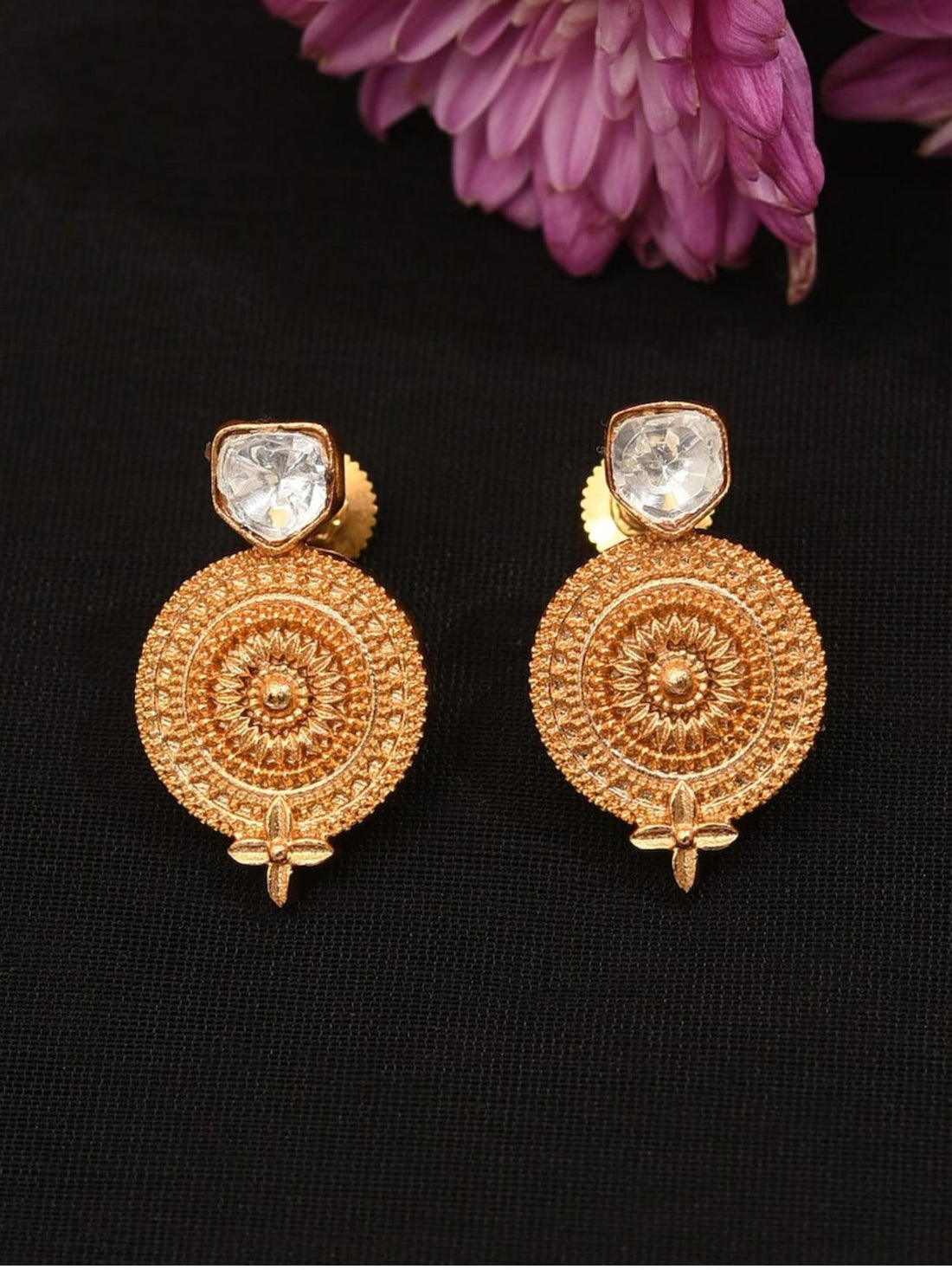 Close-up of a woman wearing Gold Plated Glass Kundan Polki Stud Earrings with intricate circular design