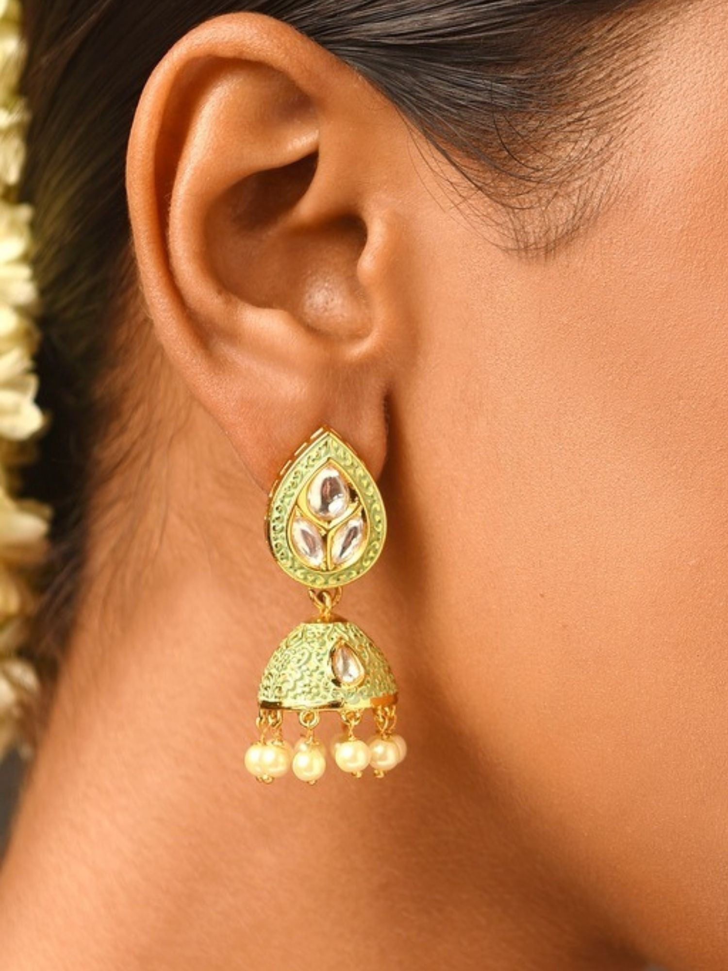 Gold Plated Green Meenakari Kundan Jhumka Earrings worn on ear by model from Abdesignsjewellery