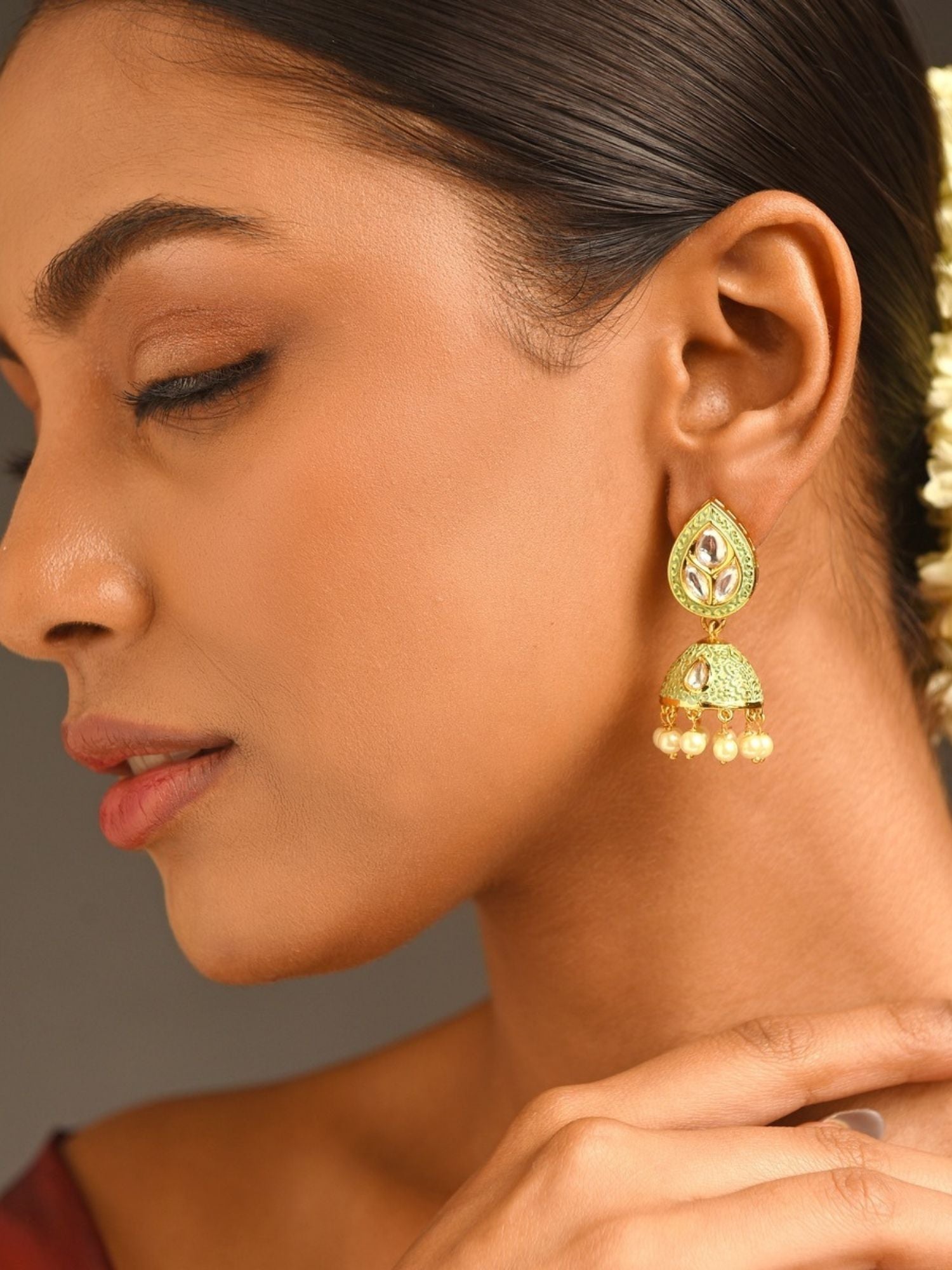 Closeup of woman wearing Gold Plated Green Meenakari Kundan Jhumka Earrings by Abdesignsjewellery