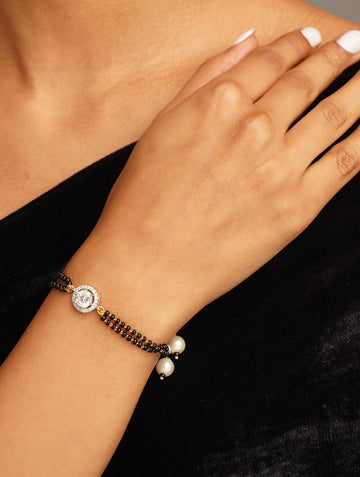 Elegant Gold Plated Hand Mangalsutra with black beads and pearl charms on wrist by Abdesignsjewellery