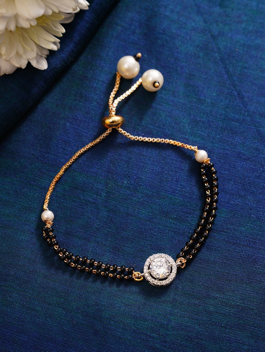 Elegant Gold Plated Hand Mangalsutra with black beads and pearl charms on wrist by Abdesignsjewellery
