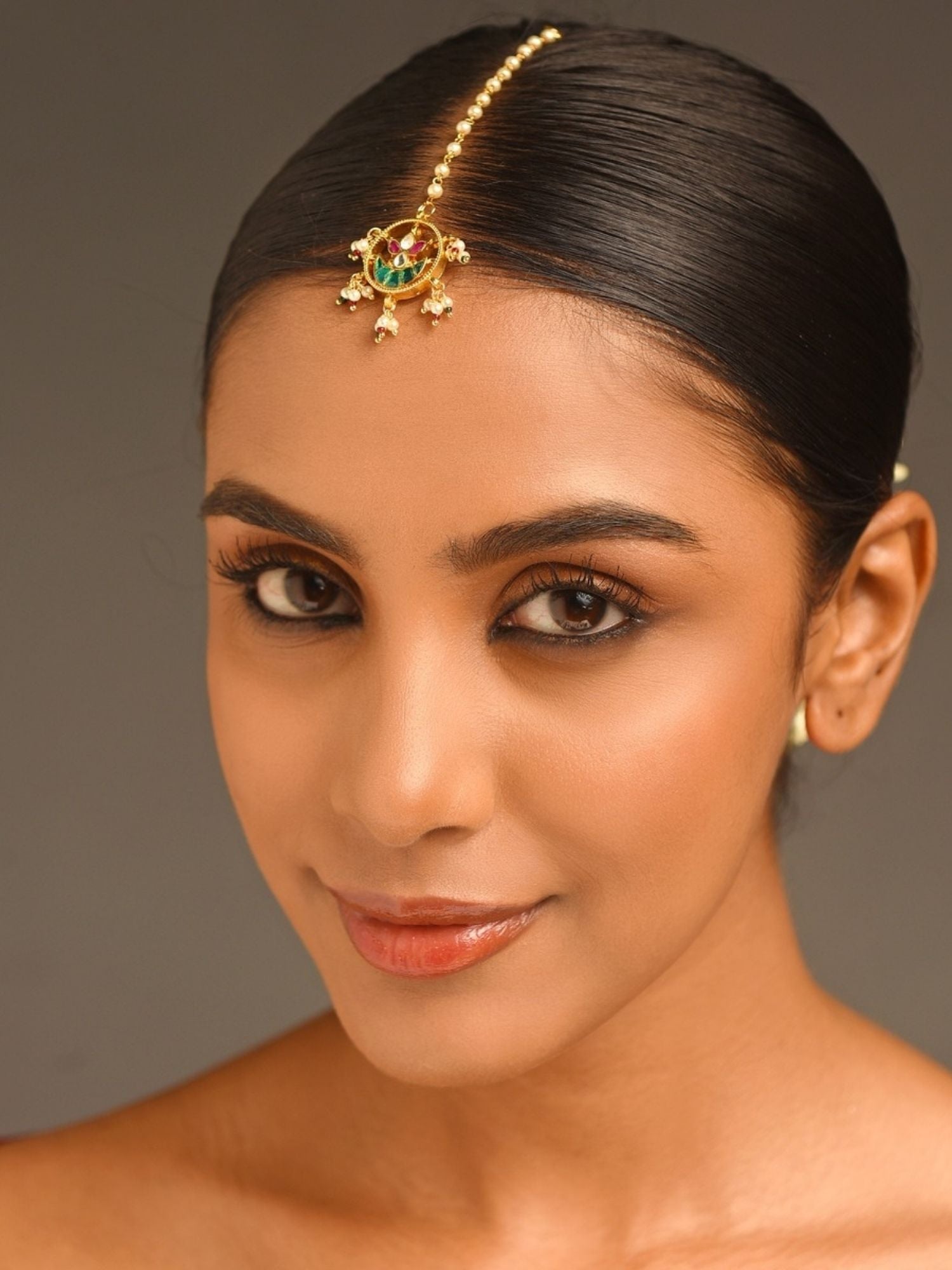Gold Plated Paachi Kundan Maangtikka worn by woman with sleek hair and natural makeup by Abdesignsjewellery