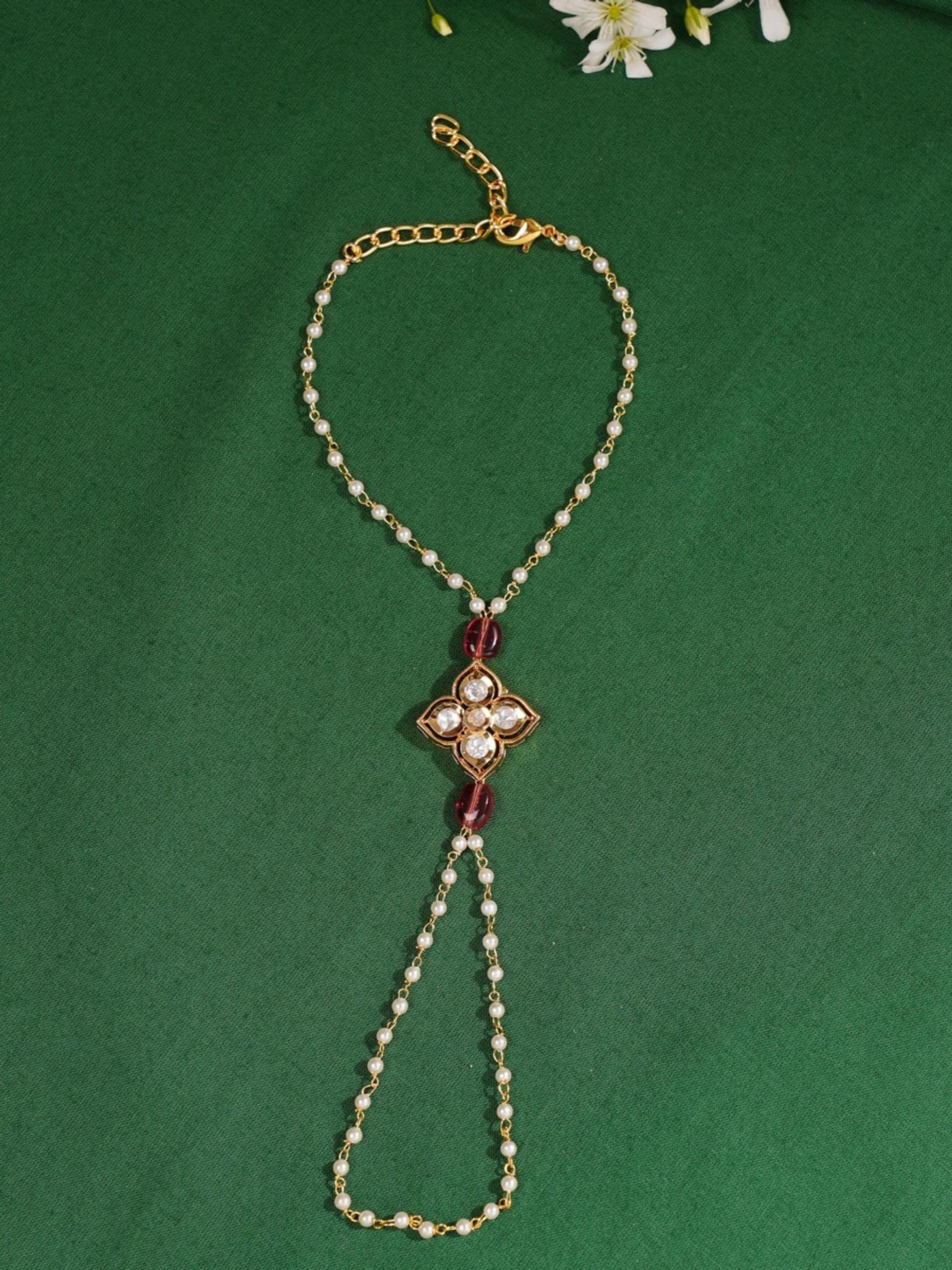 Gold Plated Polki Hand Bracelet by Abdesignsjewellery with intricate white stones and gold detailing