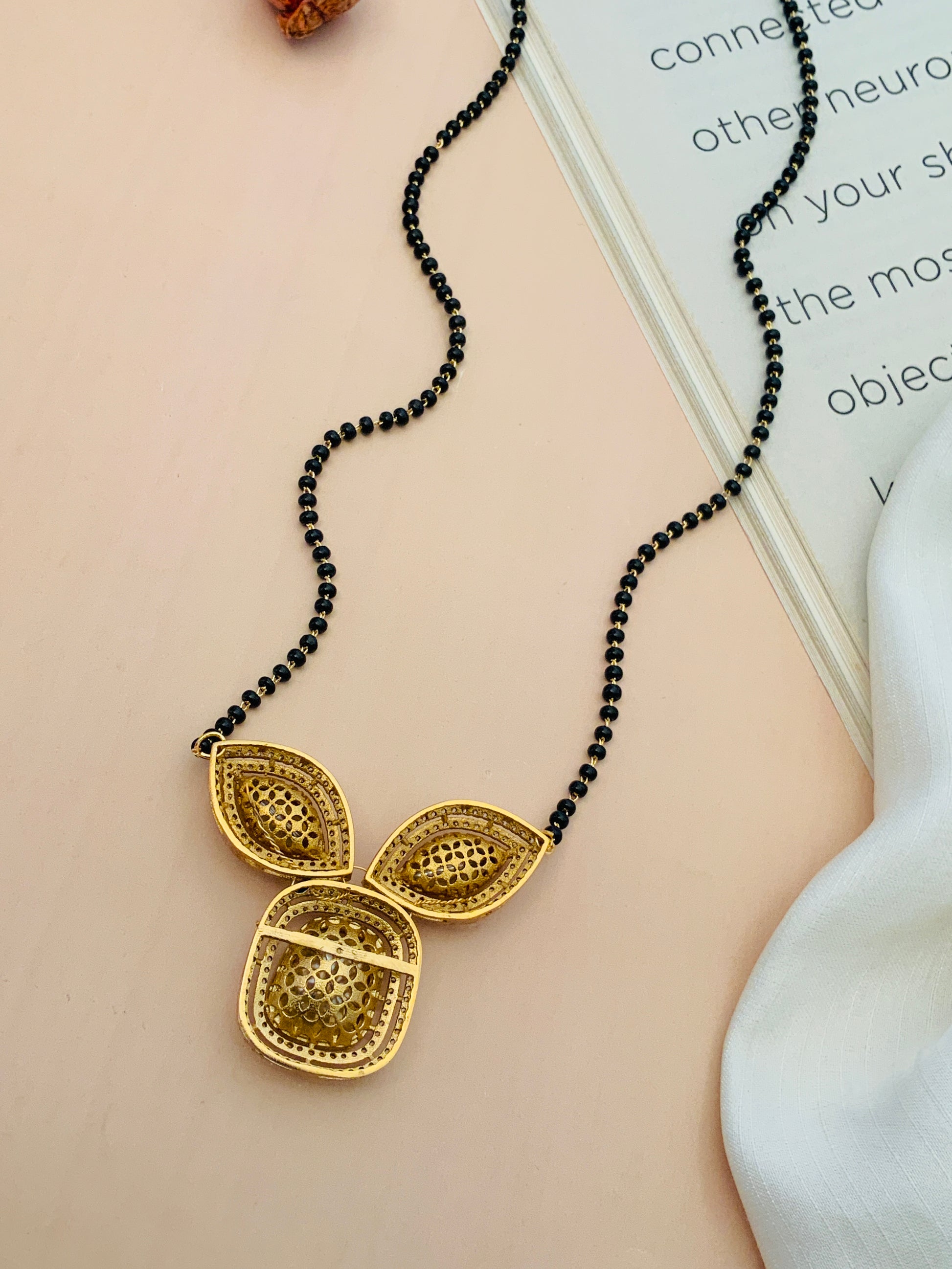 Gold Plated Polki Mangalsutra with triple leaf-shaped pendant and black bead chain by Abdesignsjewellery