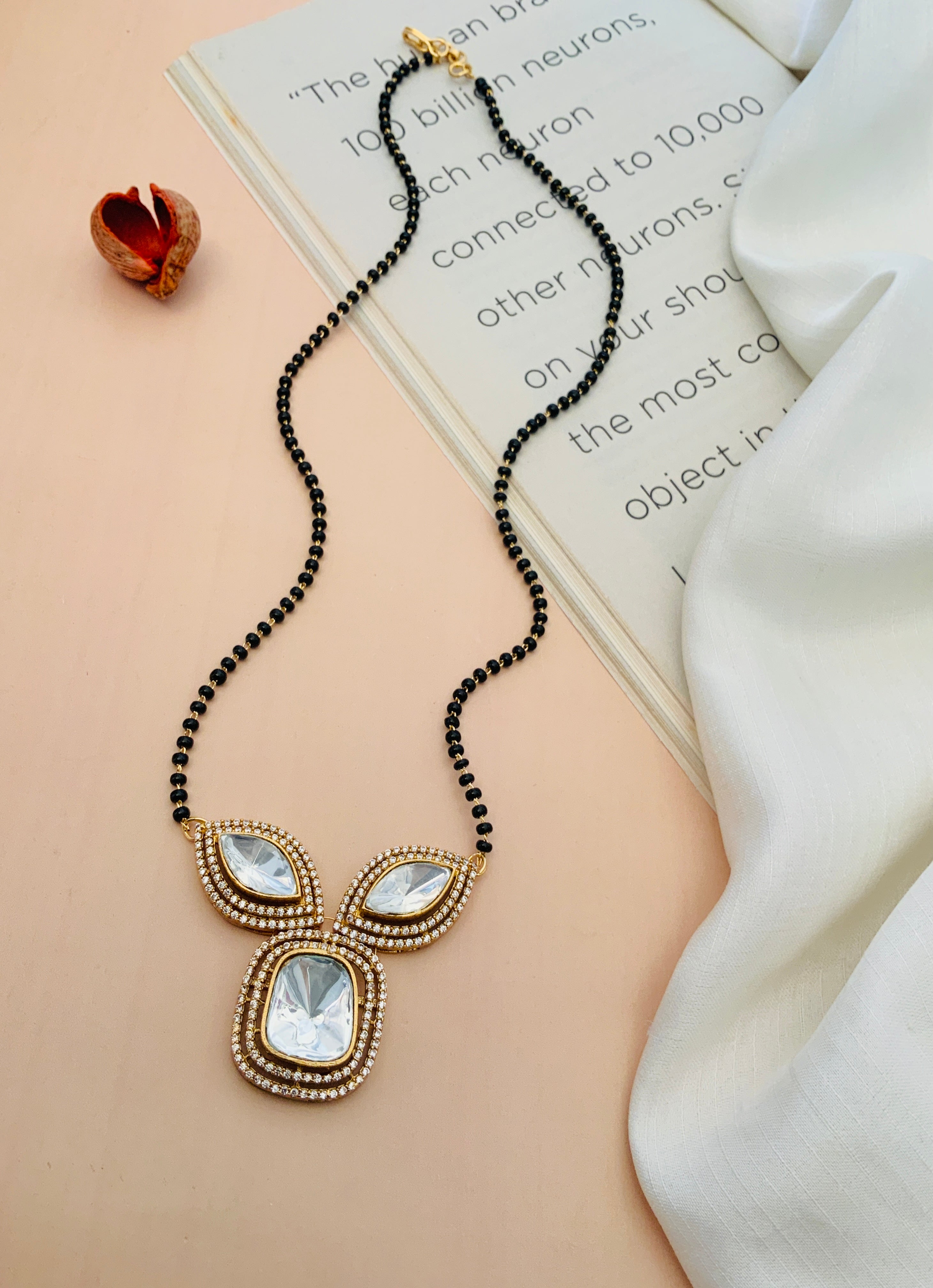 Gold Plated Polki Mangalsutra with intricate white stone design and black beads by Abdesignsjewellery