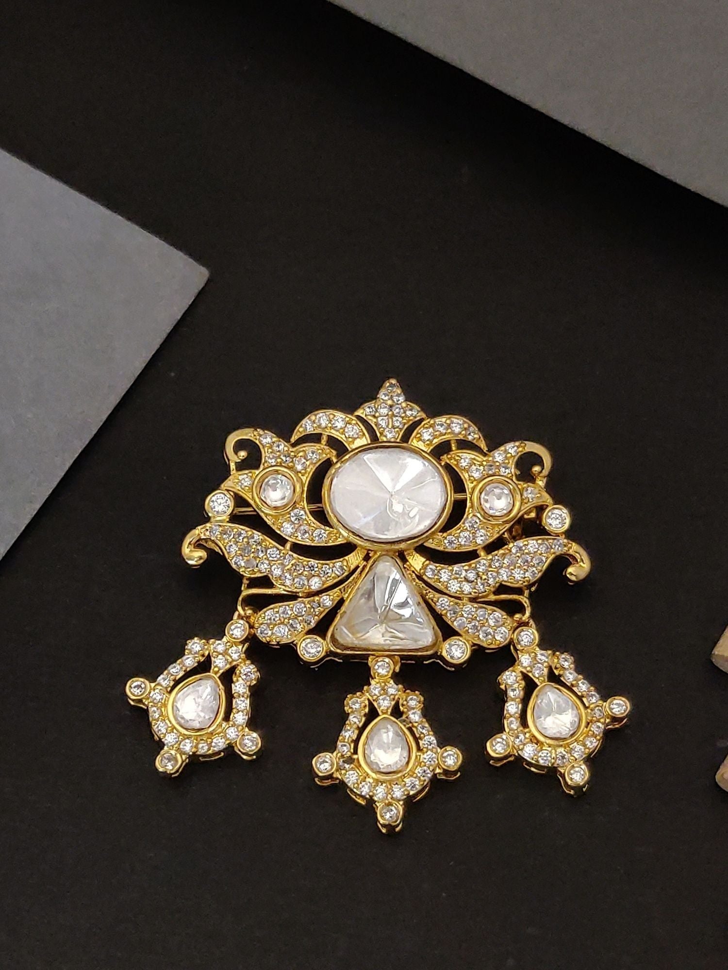 Gold Plated Polki Mens Brooch Pin with intricate design and clear stones on a dark background