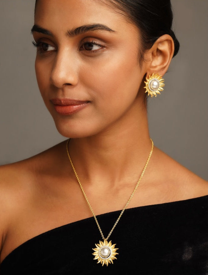 Gold Plated Polki Pendant Chain Set worn by woman featuring sunburst design pendant and matching earrings
