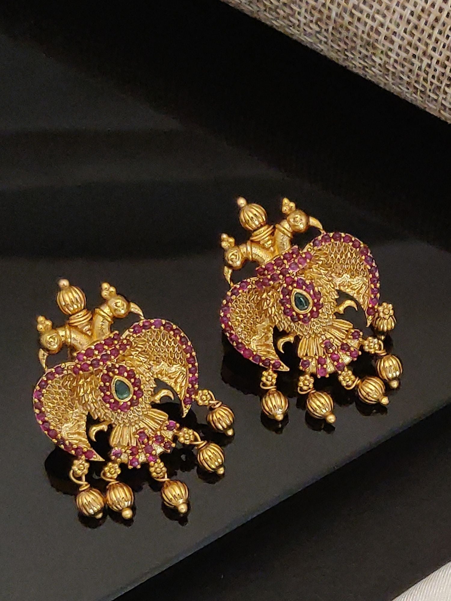 Gold Traditional Southindian Birds Earrings with intricate detailing and red gemstone accents by Abdesignsjewellery