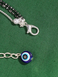 Thumbnail for Handcrafted Silver Evil Eye Foot Jewelry Anklet with blue evil eye charm and silver clasp on green fabric