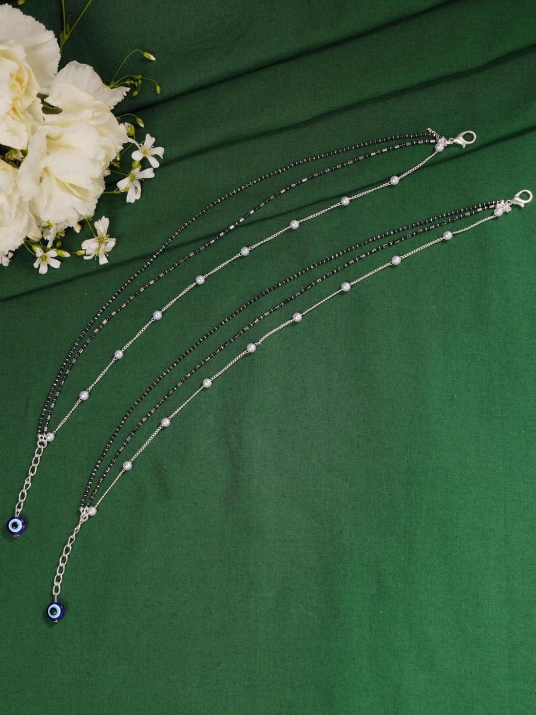 Handcrafted Silver Evil Eye Foot Jewelry Anklet worn on a model's ankle showcasing delicate silver chains