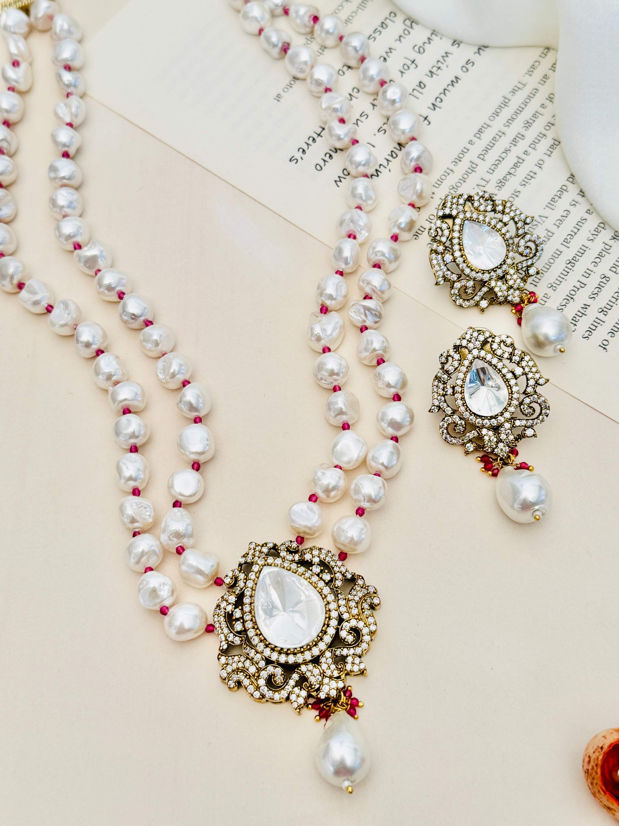 Heritage Fusion Polki Pearl Mala Set featuring double-strand pearls with intricate gold and polki pendant and matching earrings