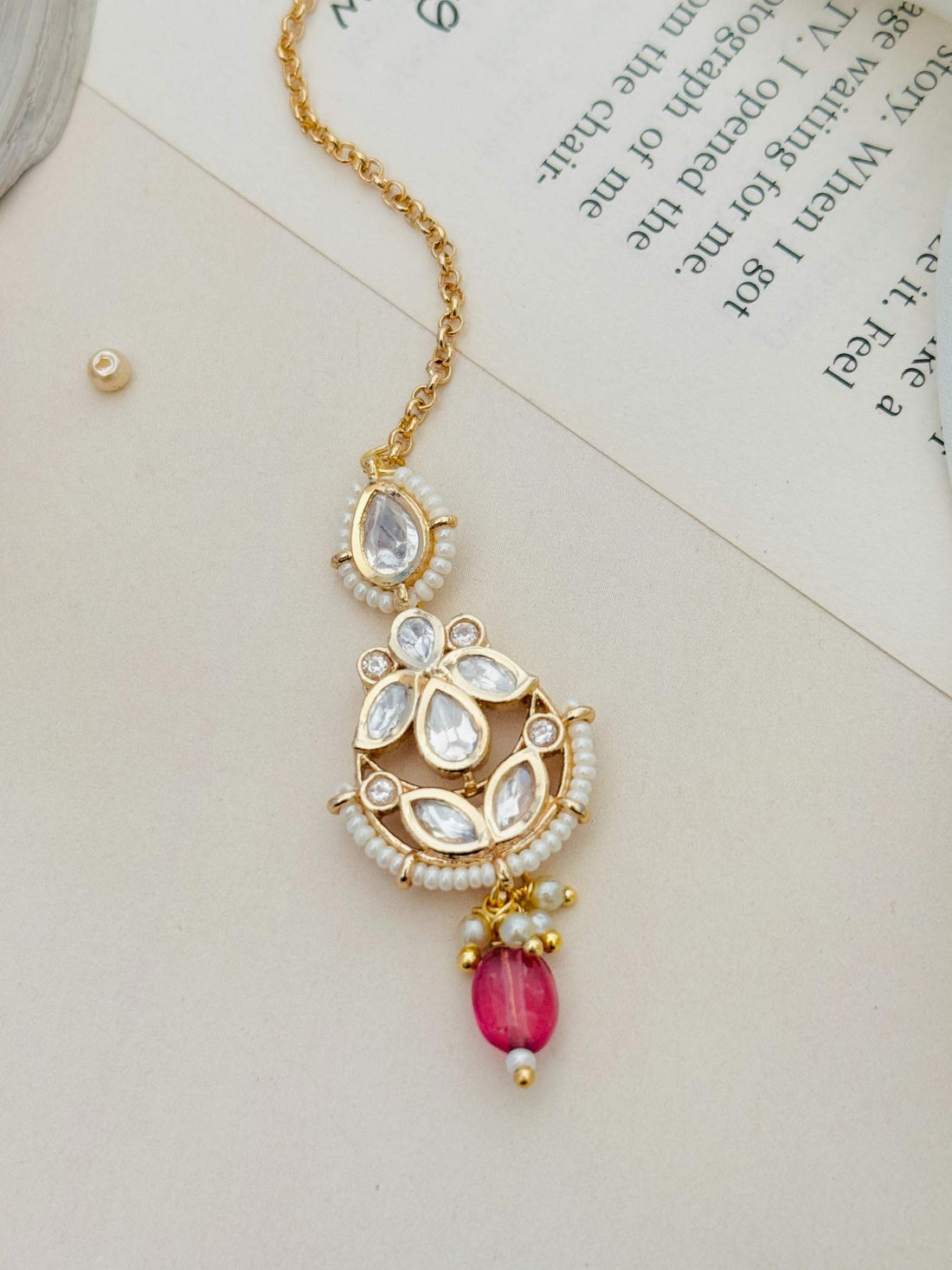 High Quality Bold Gold Plated Kundan Maangtikka worn on forehead with intricate design and red stone drop